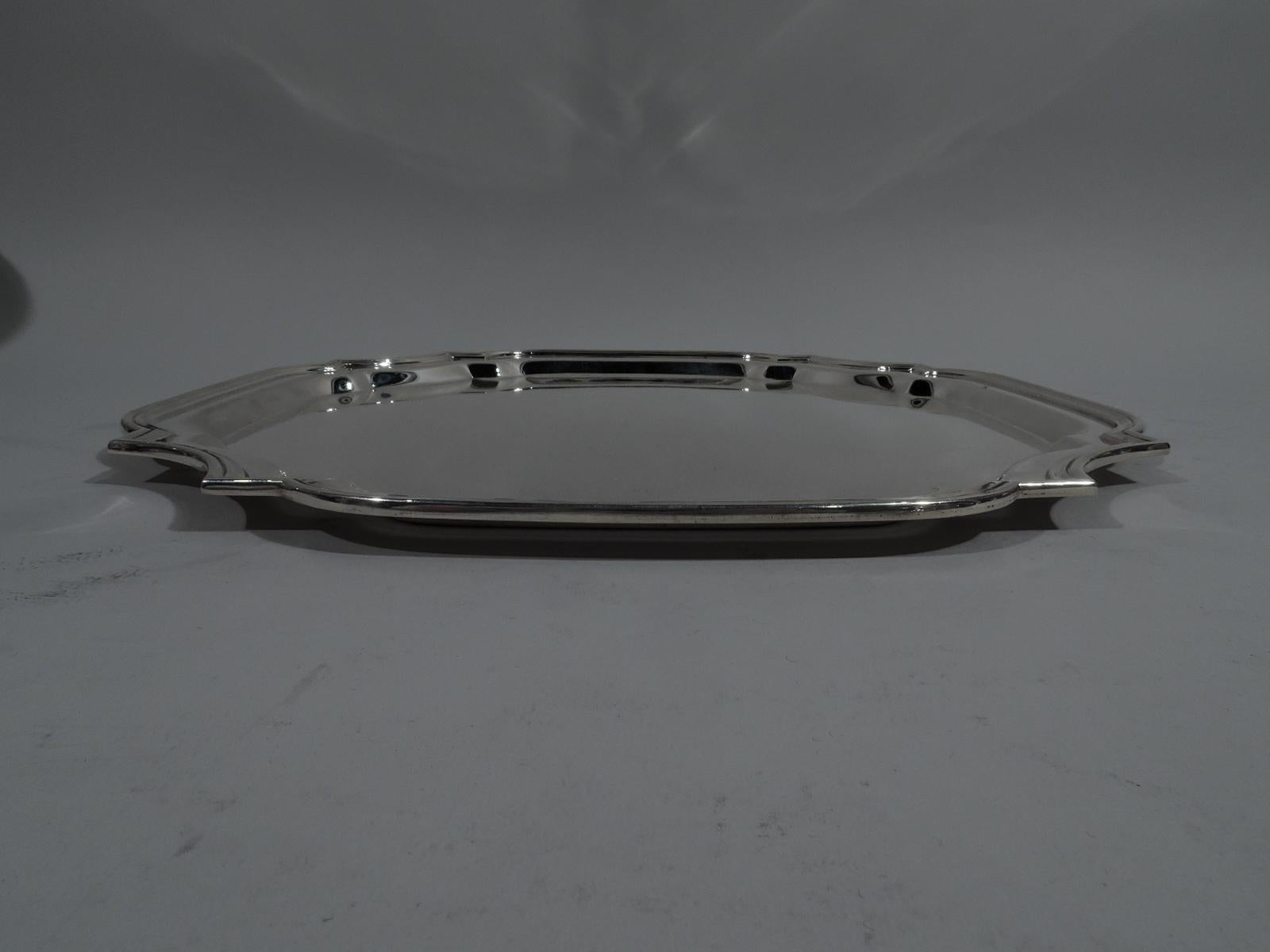 Georgian-style sterling silver tray. Retailed by Cartier in New York. Cartouche with four curved sides, curvilinear concave corners, and molded rim. Nice heft. Fully marked including retailer’s stamp and no. 2843. Heavy weight: 39.5 troy ounces.