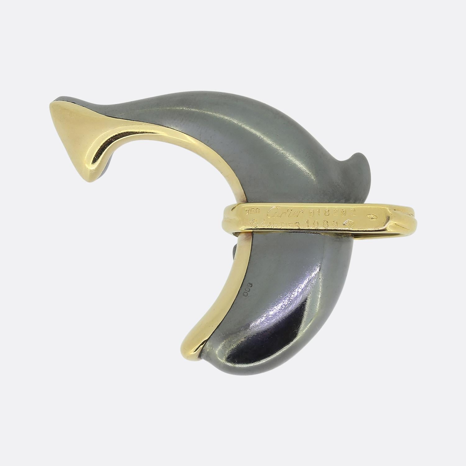 Here we have a playful pendant from the world renowned luxury jewellery house of Cartier. This piece has been crafted into the shape of a dolphin from both 18ct yellow gold and hematite to create a polished contrasted finish. A ribbed hoop acting as