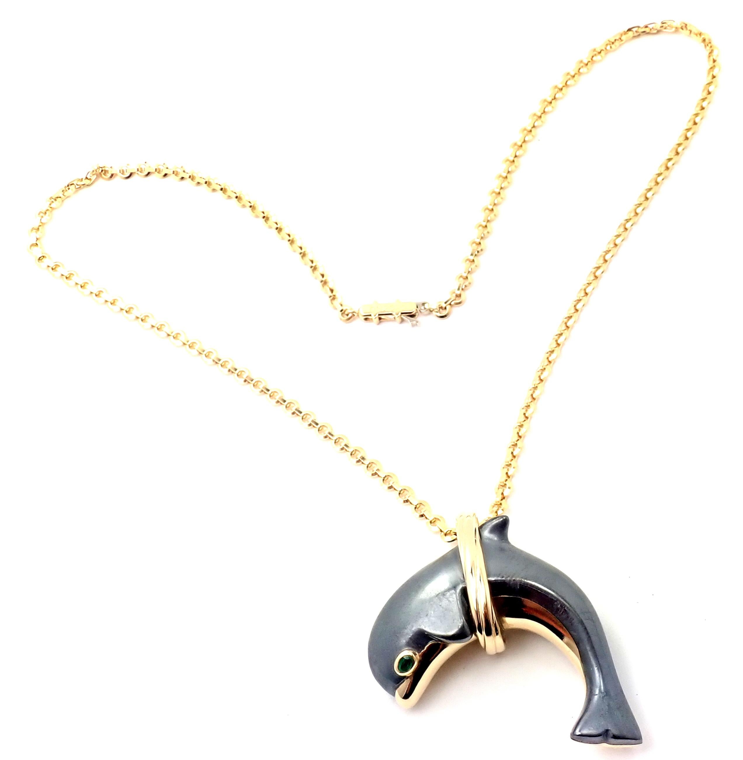 18k Yellow Gold Hematite Dolphin Pendant Necklace by Cartier. 
With 1 round emerald in the eye
Hematite stone
Details:
Pendant: 46mm x 32mm
Chain: Length: 16.5