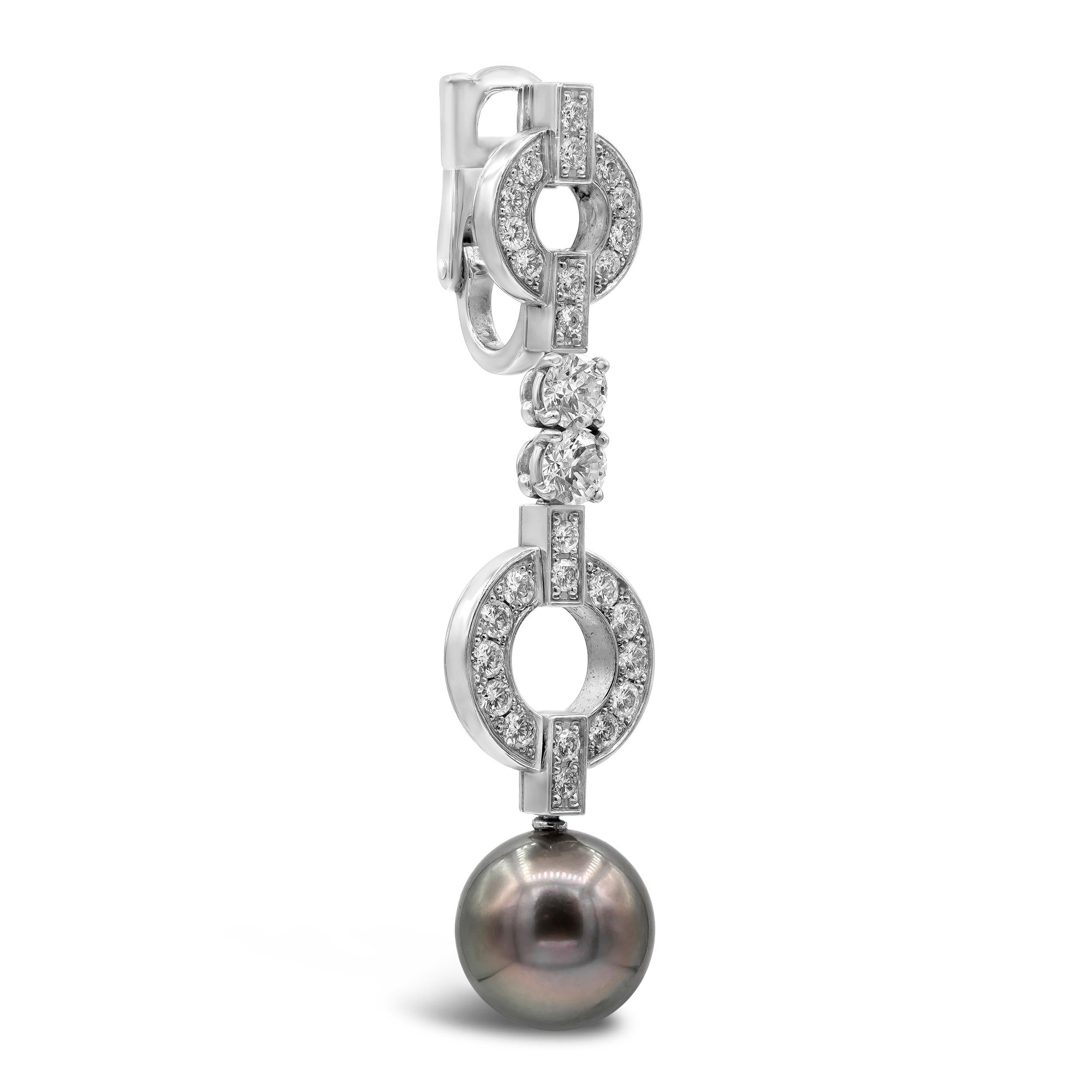 A stunning pair of Cartier Himalia diamond drop earrings featuring Tahitian pearls suspended in a diamond encrusted 18k White Gold mounting. Comes with original Cartier box and certificate of authenticity from Cartier. The earrings have a length of