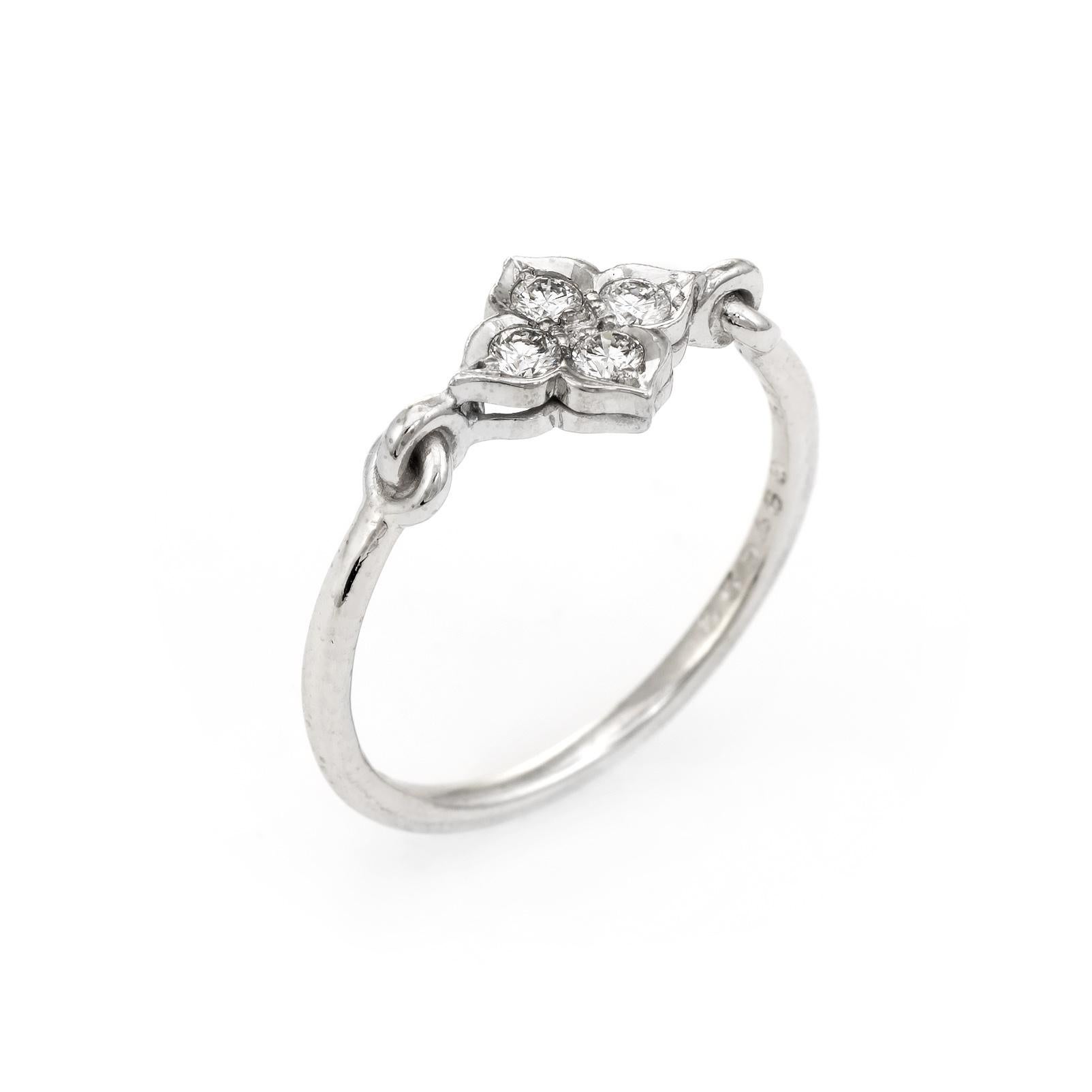 Pre owned Cartier Hindu diamond ring crafted in 18 karat white gold.  

Four round brilliant cut diamonds total an estimated 0.12 carats (estimated at F-G color and VVS2 clarity).

The out of production Cartier ring features a floral motif. The ring