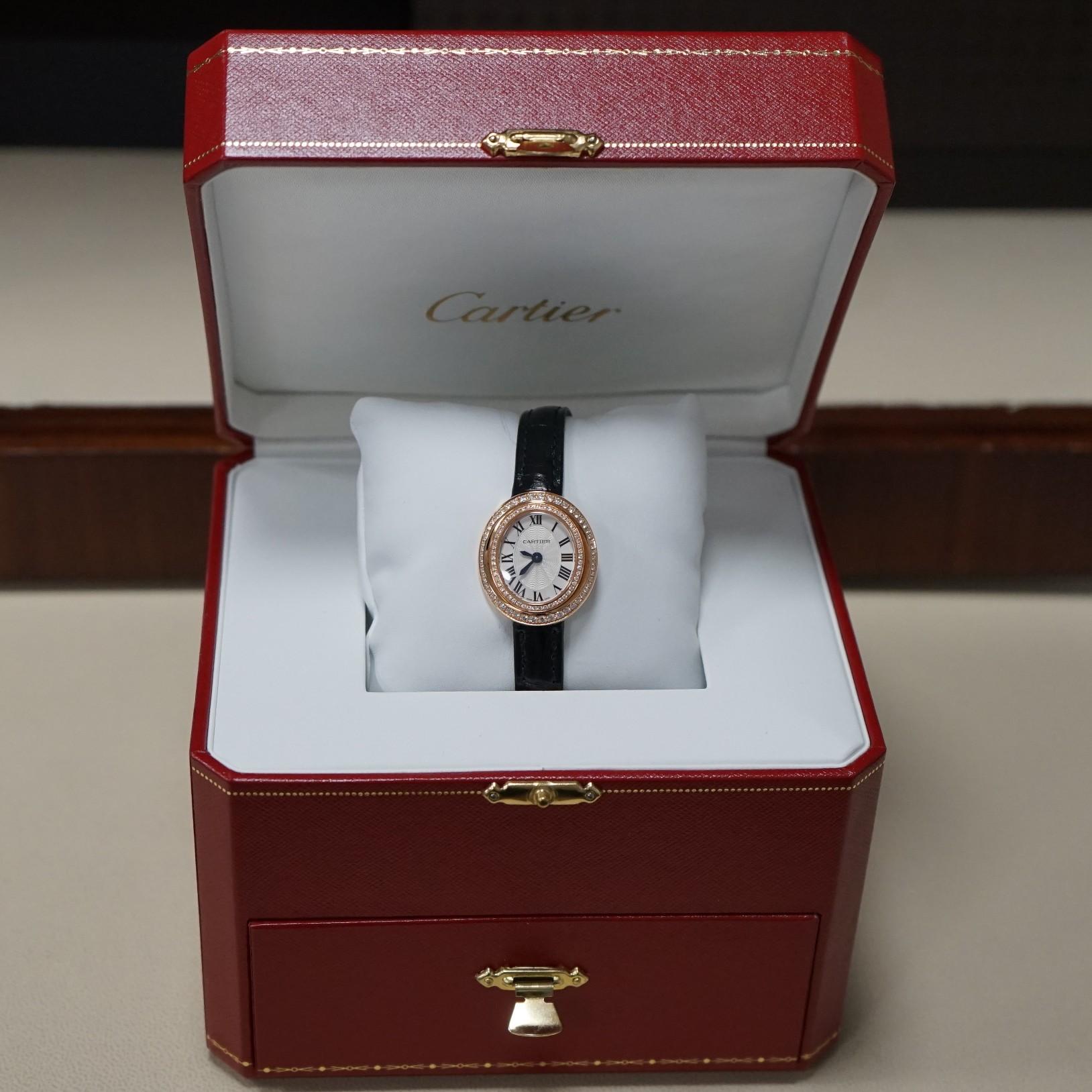 Pre- owned in excellent condition Cartier Hypnose WJHY003  in 18 Karat rose gold 30mm x 26.2mm  oval case, fixed set diamond bezel, silvered flinque sunray dial with blued steel sword shaped hands and Roman numerals hour markers, quartz movement,