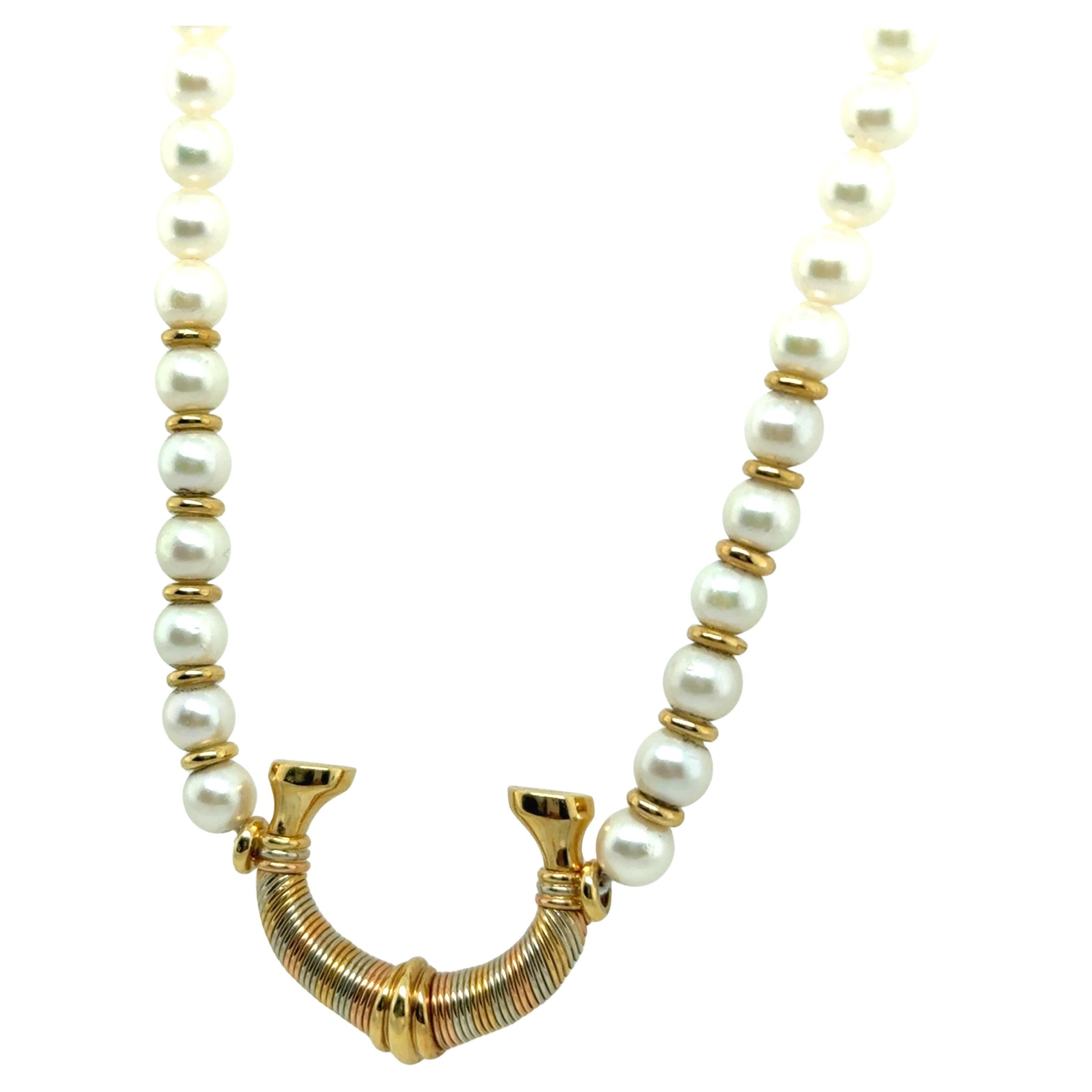 This exceptional Cartier necklace is a true masterpiece, embodying timeless elegance and unparalleled craftsmanship. Lustrous Akoya pearls are beautifully paired with polished 18-karat yellow gold accents, while the striking horseshoe-shaped gold