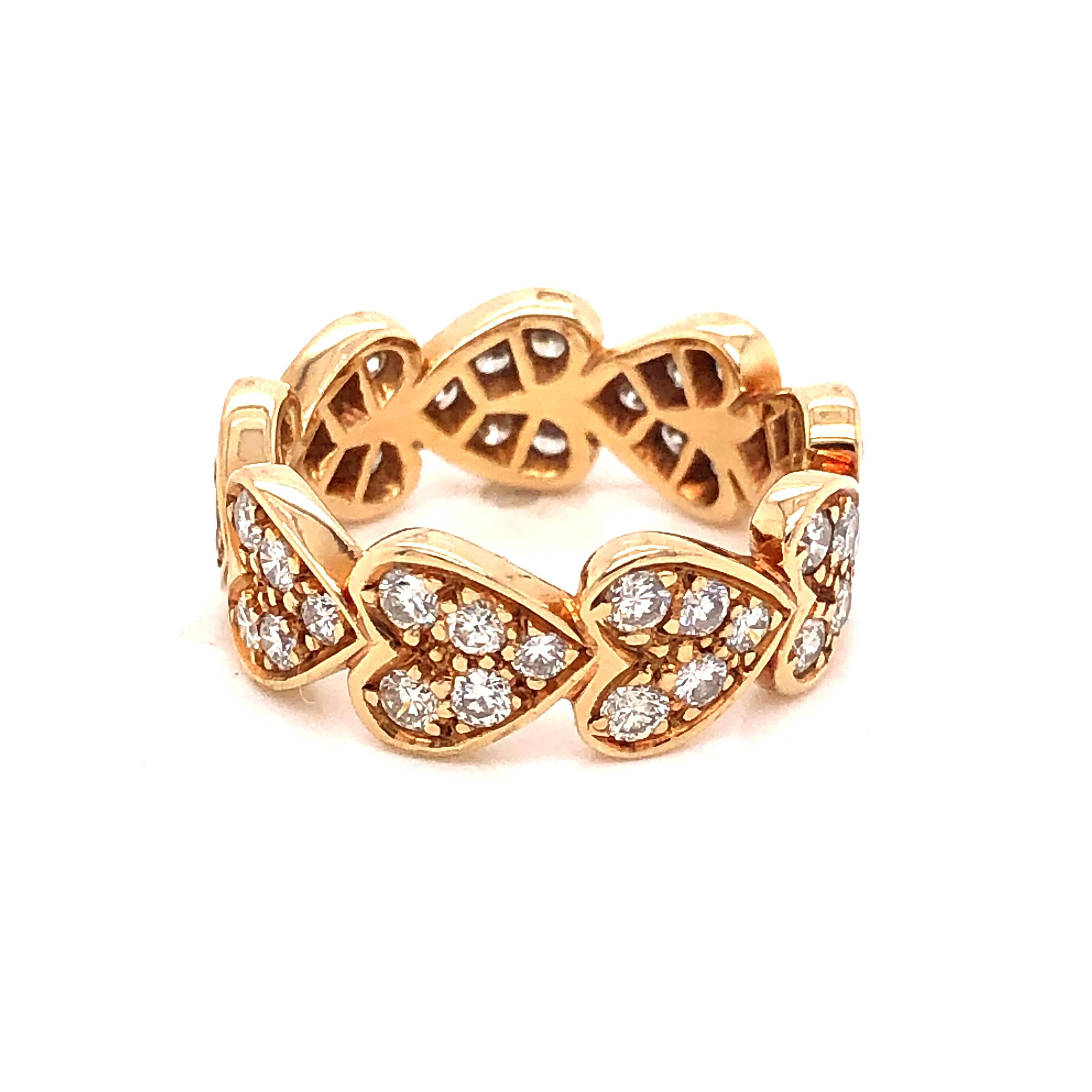 Beautiful design from famed jewelry house Cartier. Ring is crafted in 18k yellow gold and truly a breathtaking design. Rolling heart shapes complete this eternity band as each heart lays into each other in a circular pattern. Each individual heart
