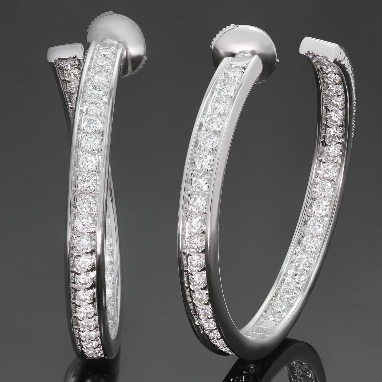 These magnificent Cartier hoop earrings feature the unique inside out design crafted in 18k white gold and set with brilliant-cut round D-F VVS1-VVS2 diamonds of an estimated 2.94 carats. Made in France circa 2000s. Measurements: 1.37