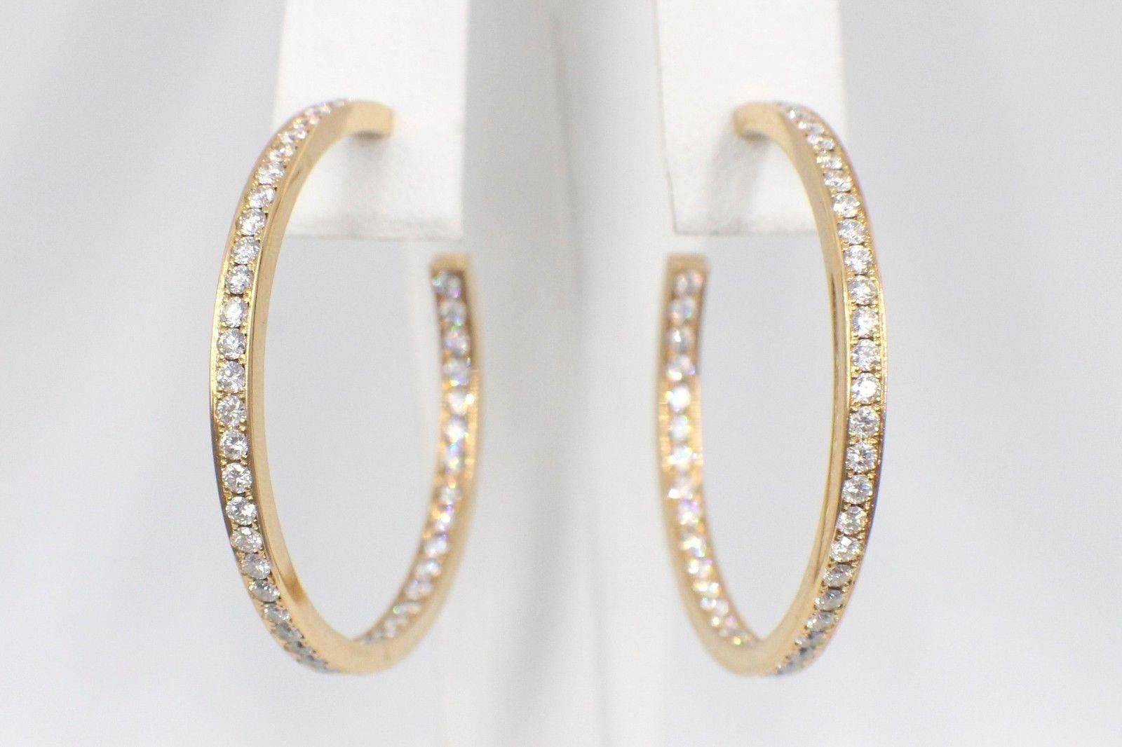 Cartier
 Inside Out Round Brilliant Cut Diamonds Hoop Earrings 
1.80 TCW F - G color, VVS clarity.  
1 3/8 Inches in Diameter or 34 MM - 2.64  MM Width  
Hallmark 