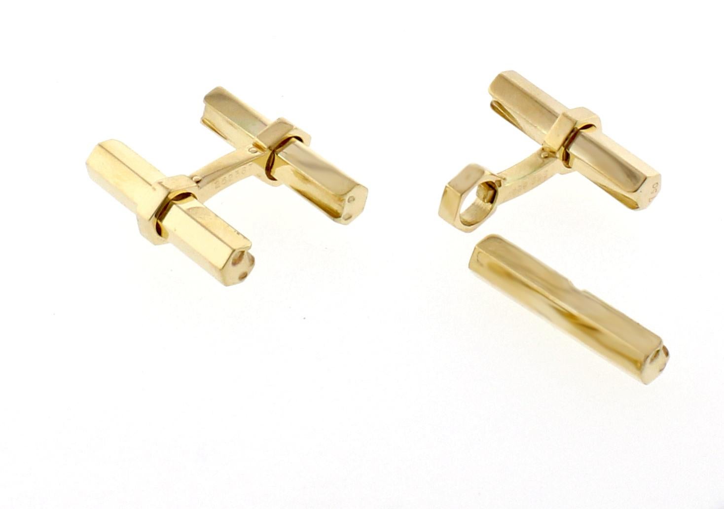 From Cartier, a pair of  18 karat cufflinks with an interchangeable hexagonal gold bar. 
