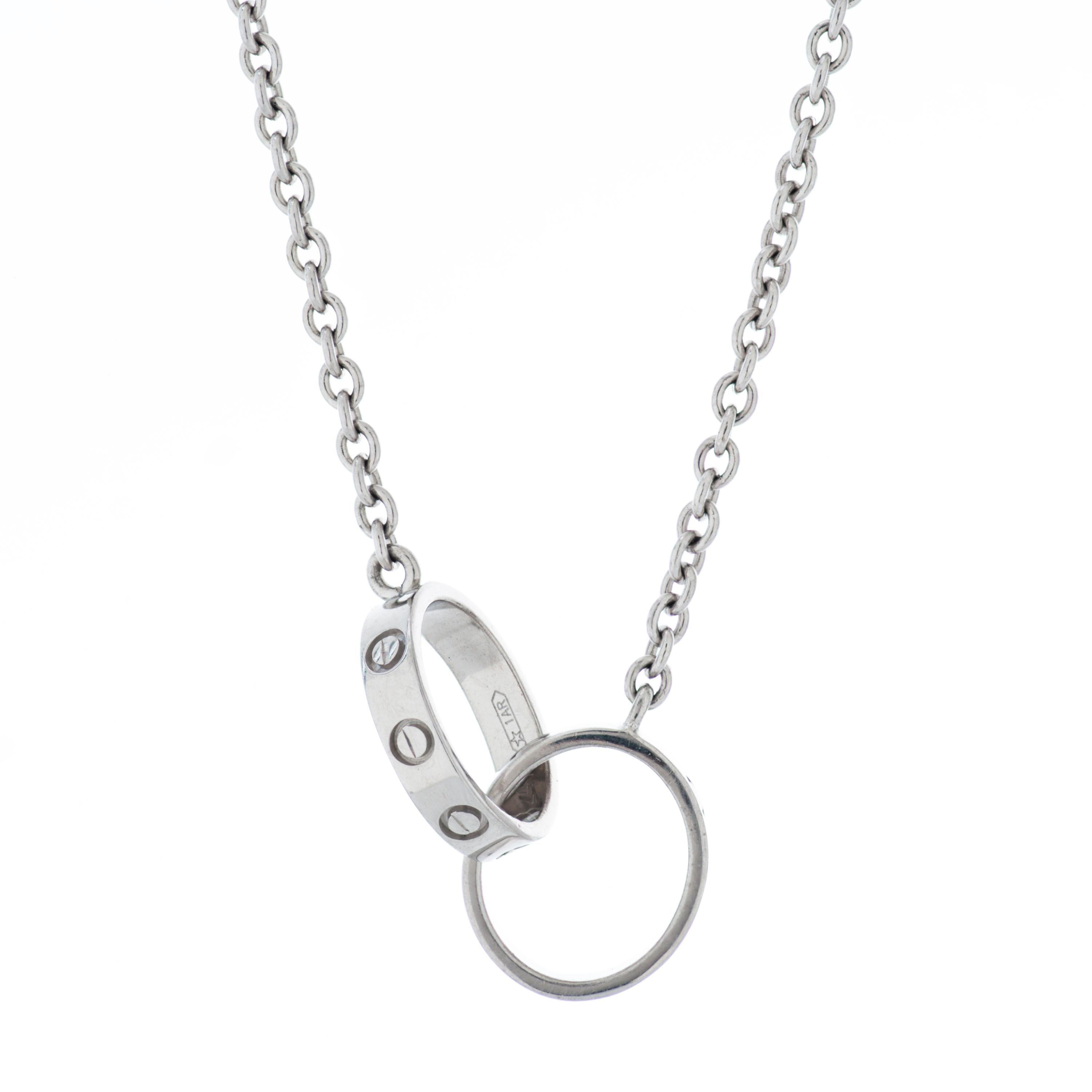 Cartier Love necklace in 18k white gold.

This Cartier necklace features two interlocking Love bands measuring approximately 10mm each, attached to a 17 inch long 1.8mm thick chain.  

7.1 grams.
Numbered and signed Cartier.