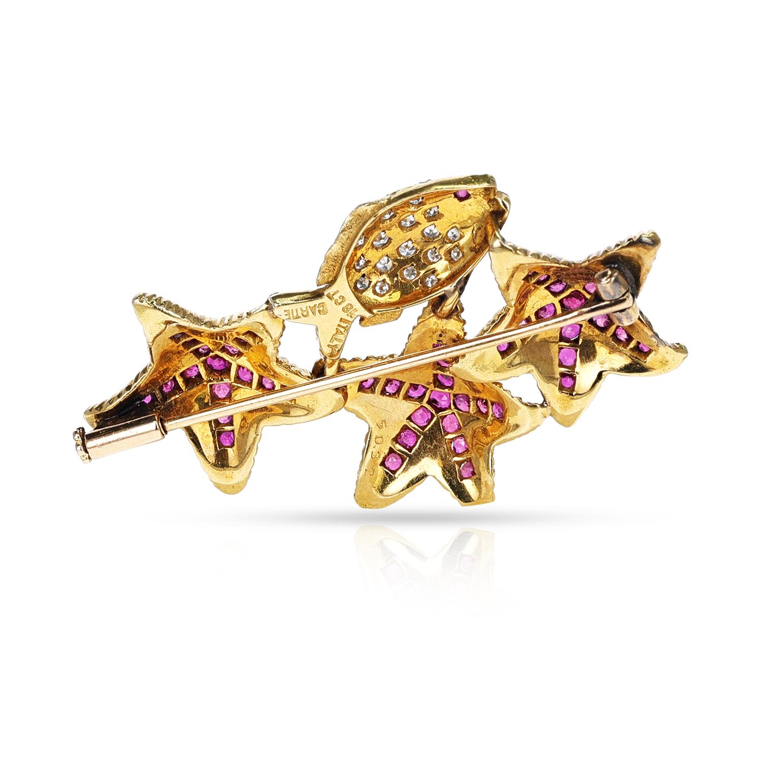 A Cartier Italy Ruby and Diamond Fish and Starfish Brooch/Pin made in 18 Karat Yellow Gold. The length is appx 5 x 3 CM. 