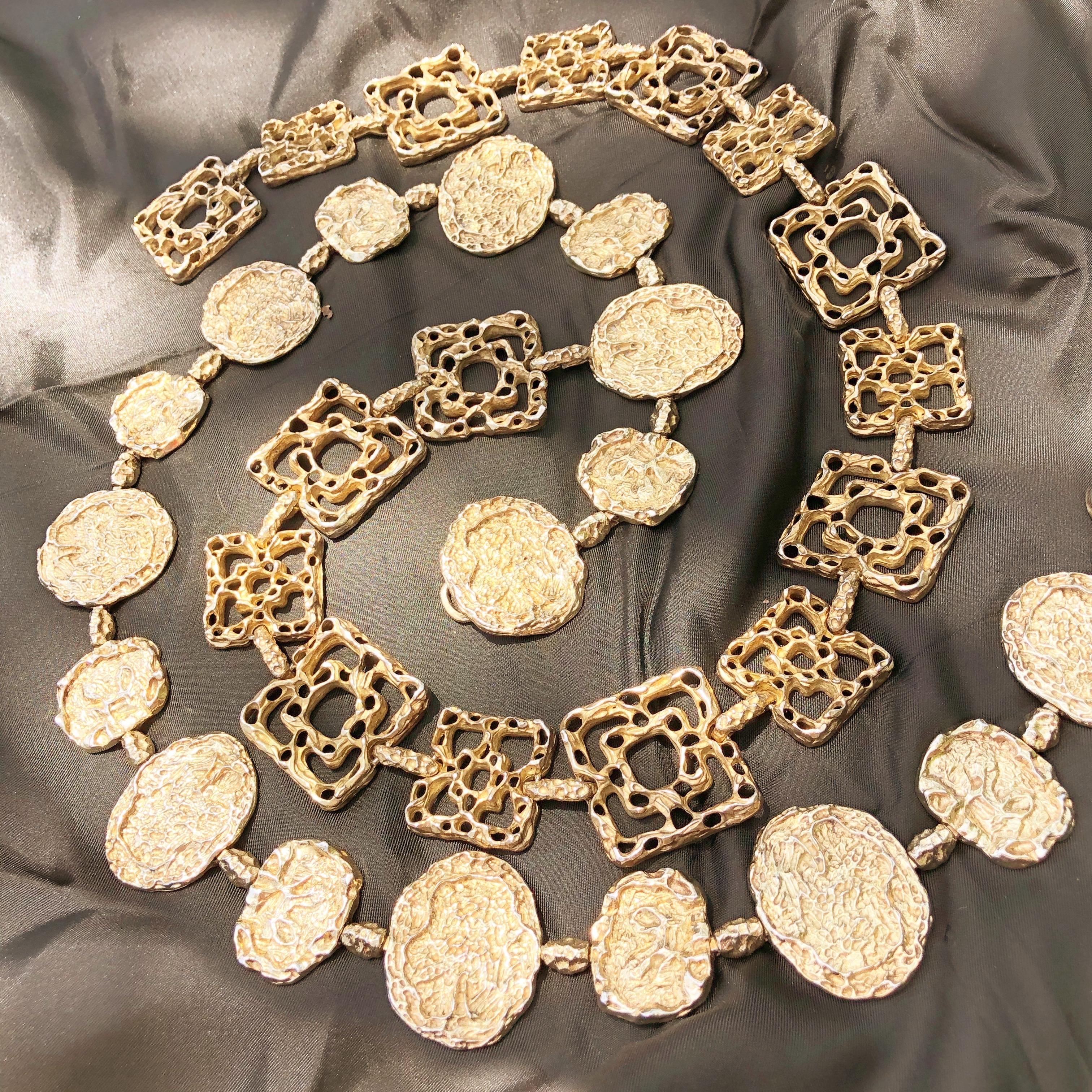 This stunning and iconic gold vermeil belt by Cartier, circa 1970, doubles as a chunky statement necklace. This highly sought after and coveted belt is made from solid sterling silver covered in 24 karat gold, is marked 