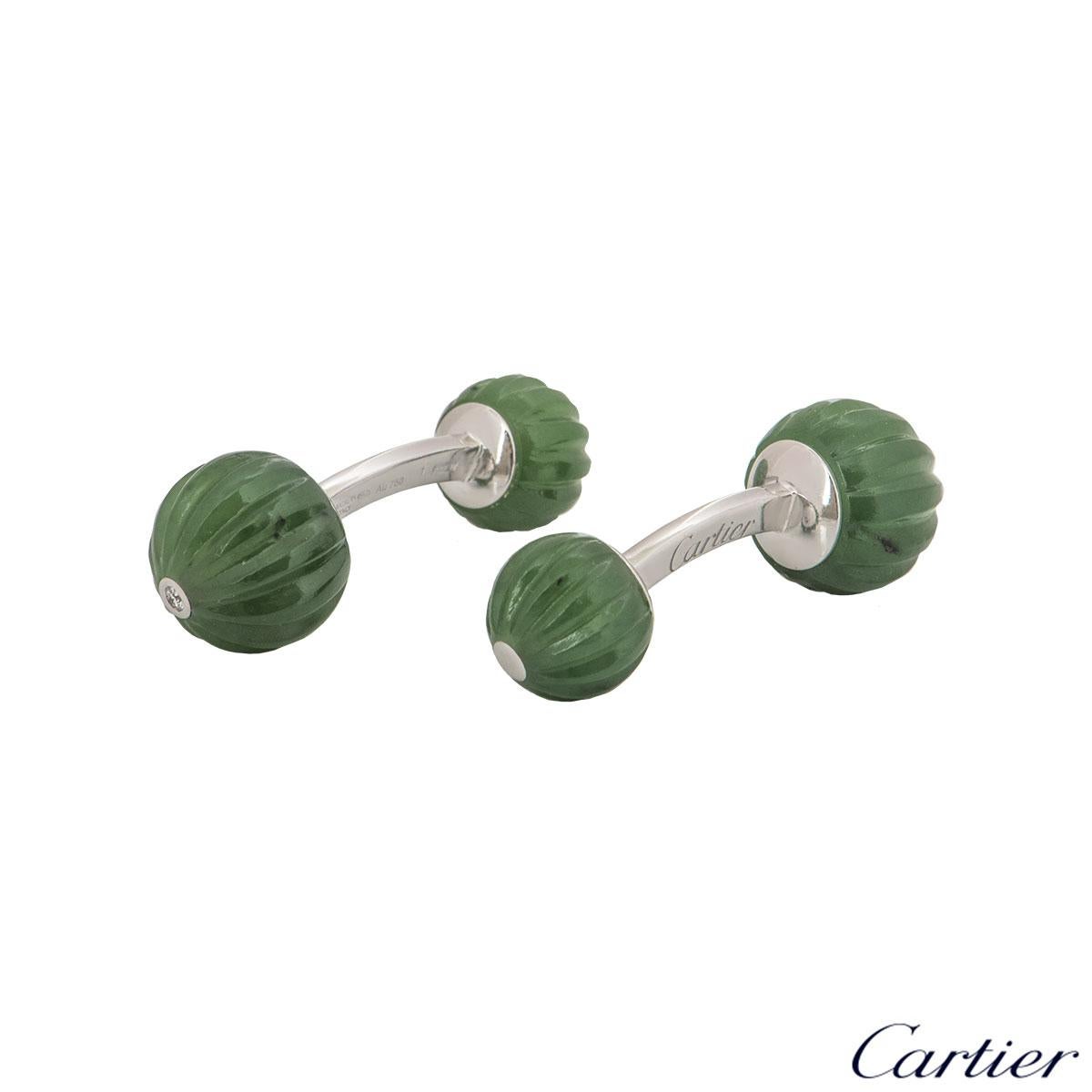 An alluring 18k white gold pair of cufflinks by Cartier. The cufflinks feature 4 jade beads in alternate sizes with a single diamond at the tip of the largest bead. The cufflinks are encased together by a bar fitting with a length of 3.00cm with a