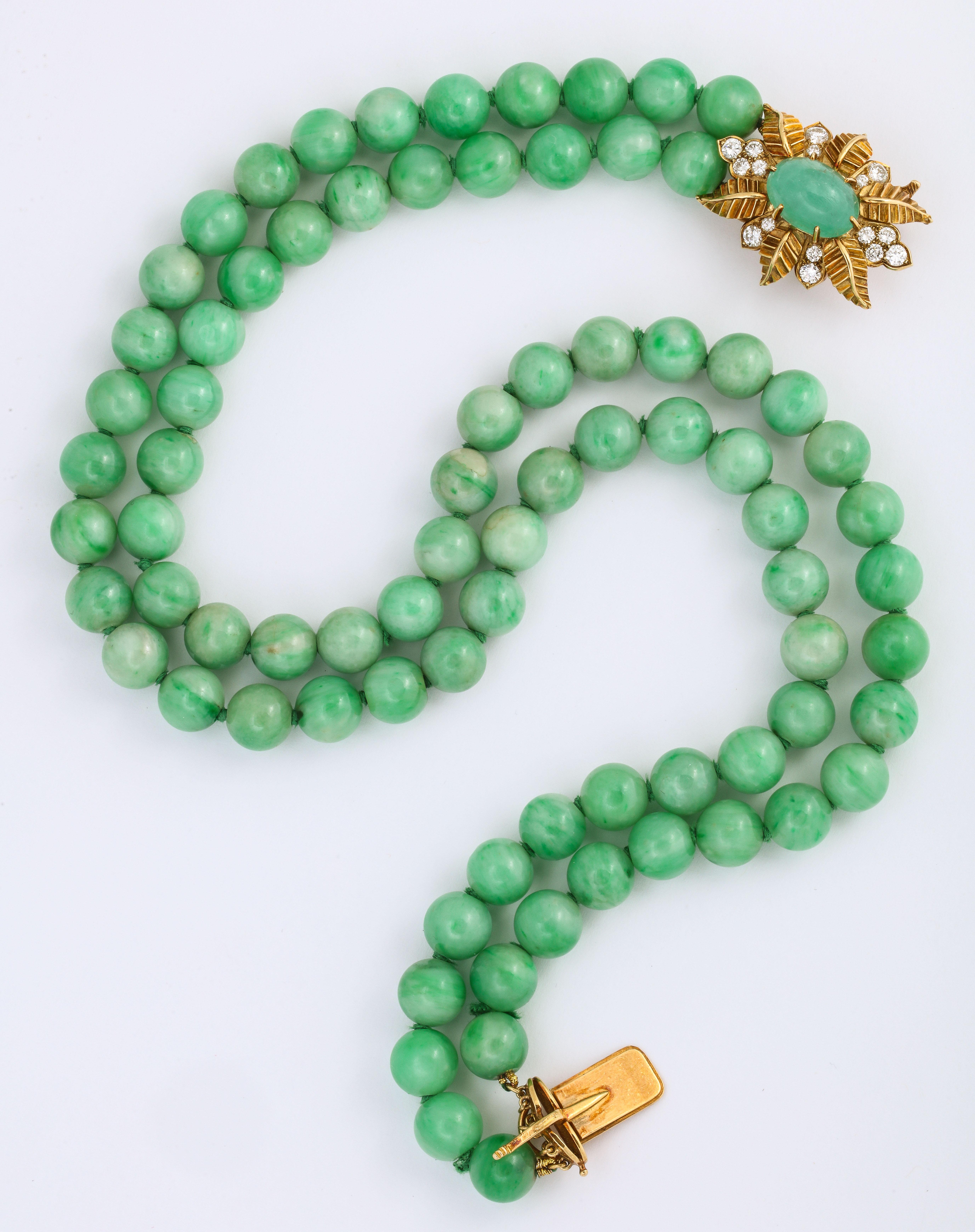 Offered is this elegant Cartier Jade Bead Choker Necklace, 16-17 inches long, circa 1950. The clasp is in a floral pattern of 16 Fine White Full Cut Diamonds at 1.50 cts tw and 87.2 dwt, set in 18K yellow gold and centered with an oval shaped jade