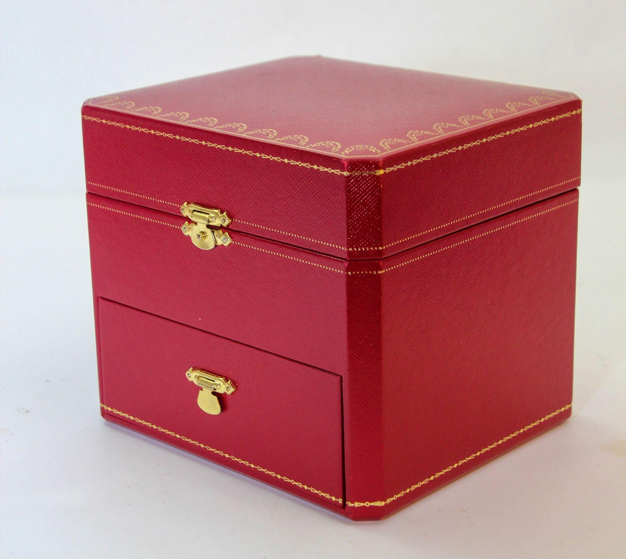 
Cartier Red Leather Gilt Embossed Jewelry Storage travel box.
Cartier watch and jewelry presentation box.
Elegant wristwatch case with a drawer for small jewelry.
A top room box for securely storing your watch and a lower jewelry drawer tray to