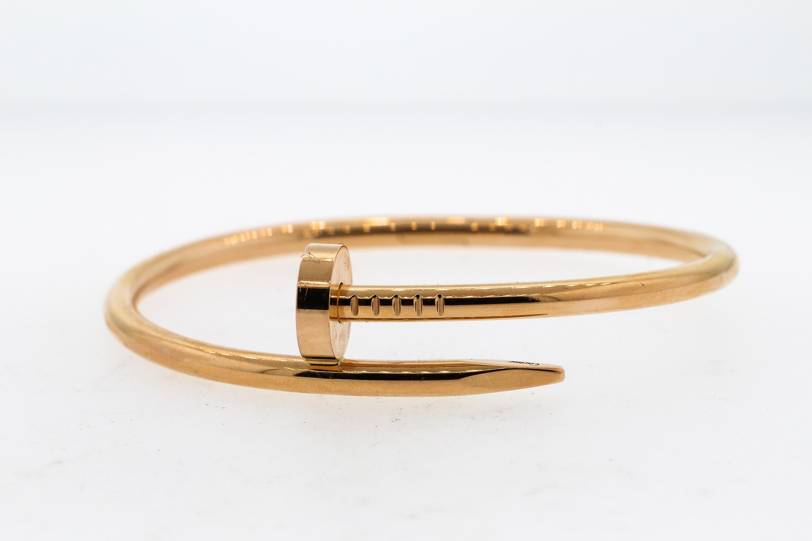 An authentic Juste un Clou bracelet by Cartier made in 18K rose gold. This hinged bracelet is size 16 (referring to 16 cm circumference). The bracelet is stamped Cartier 16 GBN663 Au750 (referring to 18k gold). There are makers marks. The bracelet