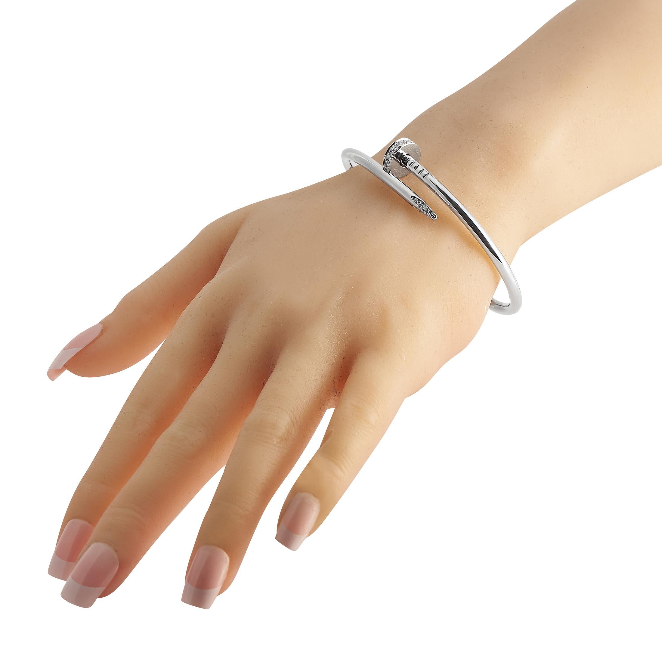 The Cartier Juste un Clou 18K White Gold Diamond Ladies Bangle Bracelet is your classic white gold diamond bracelet with an edgy twist. It features Cartier's popular nail motif where the nail silhouette is shaped into a rigid bracelet complete with