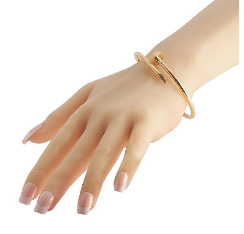 Rugged yet elegant, this Cartier Juste un Clou 18K yellow gold bracelet is the perfect accessory to give your everyday wear an extra edge. The bangle bracelet is crafted in solid 18K yellow gold with a nail head and tail design, plus a hinged