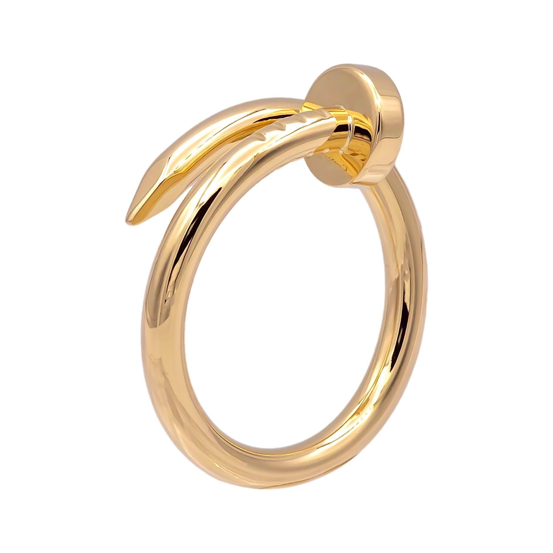 Pre-Owned Cartier ring from the Juste Un Clou collection finely crafted in 18 karat yellow gold in a nail motif wrap design. This is the large model. The ring measures 2.65 mm wide. Ring is fully hallmarked with logo, serial numbers and metal