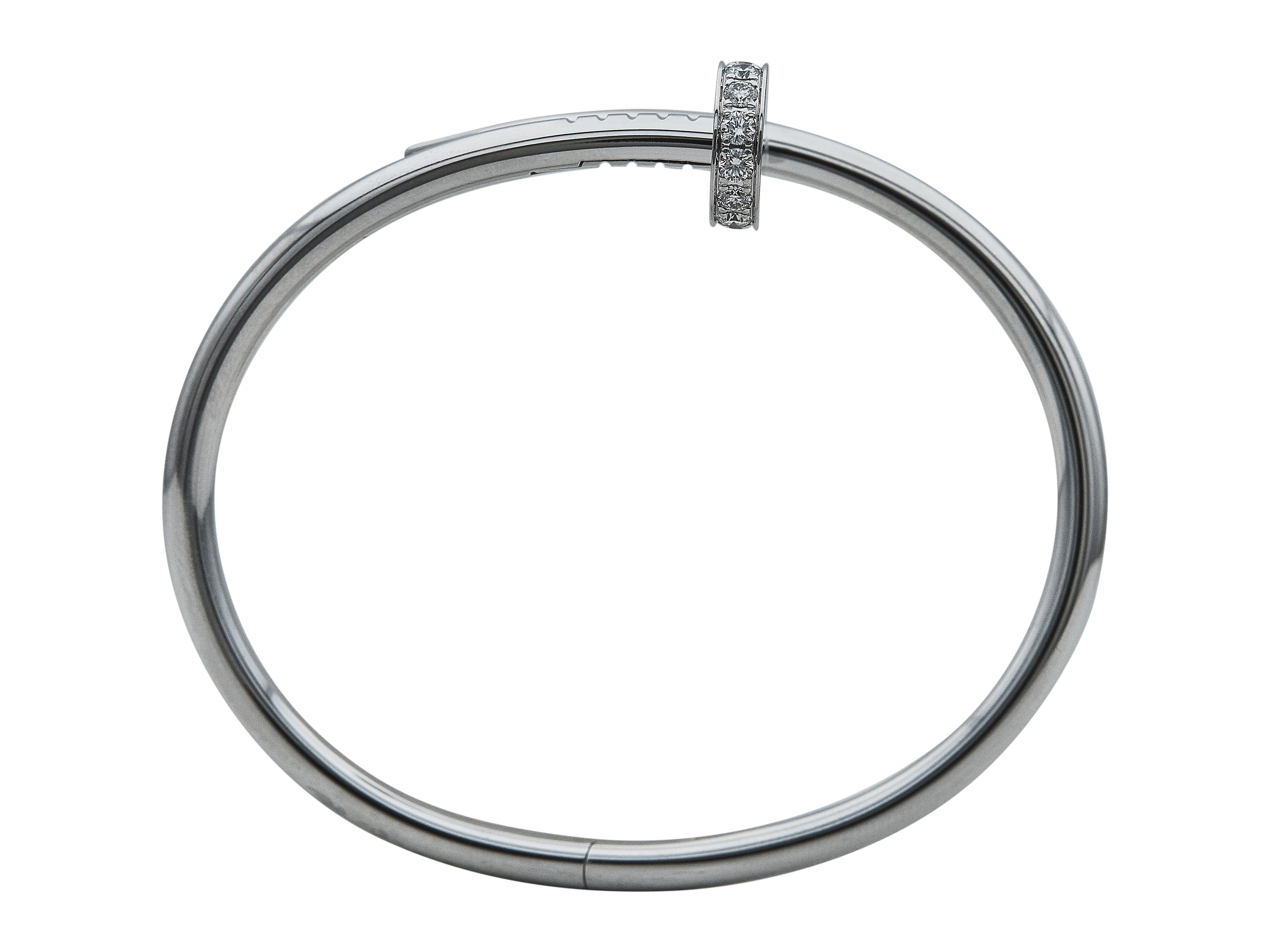 The bracelet: A Cartier Juste un Clou bangle bracelet. This Classic Model is composed of eighteen karat white gold and enhanced with round brilliant cut damonds. It is a size 16. 

Accompanied by…
Service paper

The bracelet is in excellent