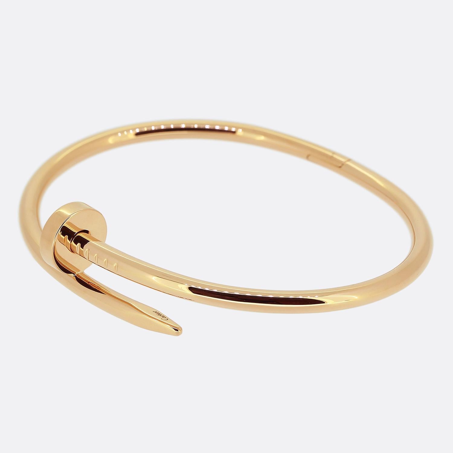 Here we have an 18ct rose gold bracelet from the luxury jewellery house of Cartier. The particular piece forms part of the world renowned Juste un Clou collection and showcases a wrap around nail design. This is the larger model with a hinged