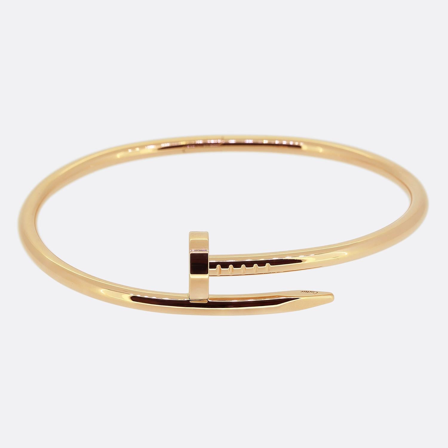Here we have an 18ct rose gold bracelet from the luxury jewellery house of Cartier. The particular piece forms part of the world renowned Juste un Clou collection and showcases a wrap around nail design. This is the larger model with a hinged