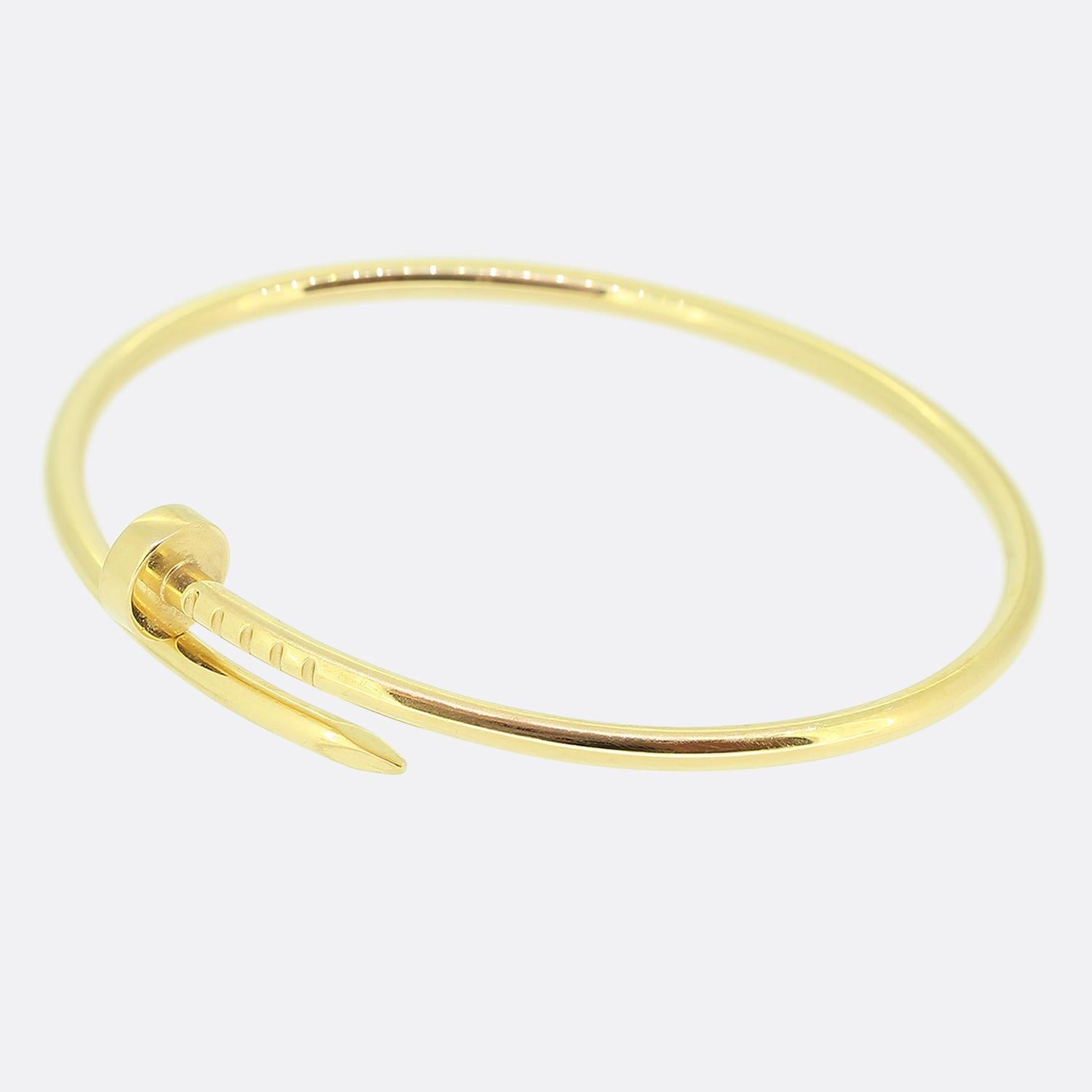 Here we have an 18ct yellow gold bracelet from the luxury jewellery house of Cartier. The particular piece forms part of the world renowned 'Juste un Clou' collection and showcases a wrap around nail design. This is the small model which allows the