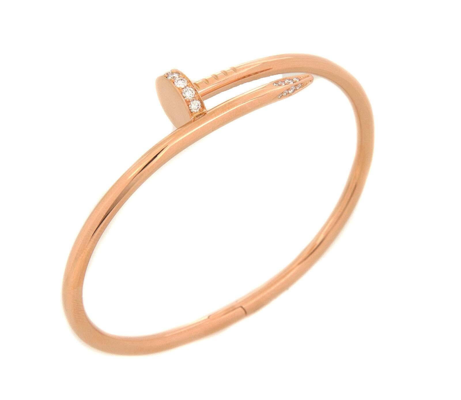 This is a chic authentic bangle by Cartier from the Juste un Clou Collection. It is crafted from 18k pink gold with a polished finish featuring a long nail wrap into a bangle in the bypass design. The head and tip of the nail is flat and decorated