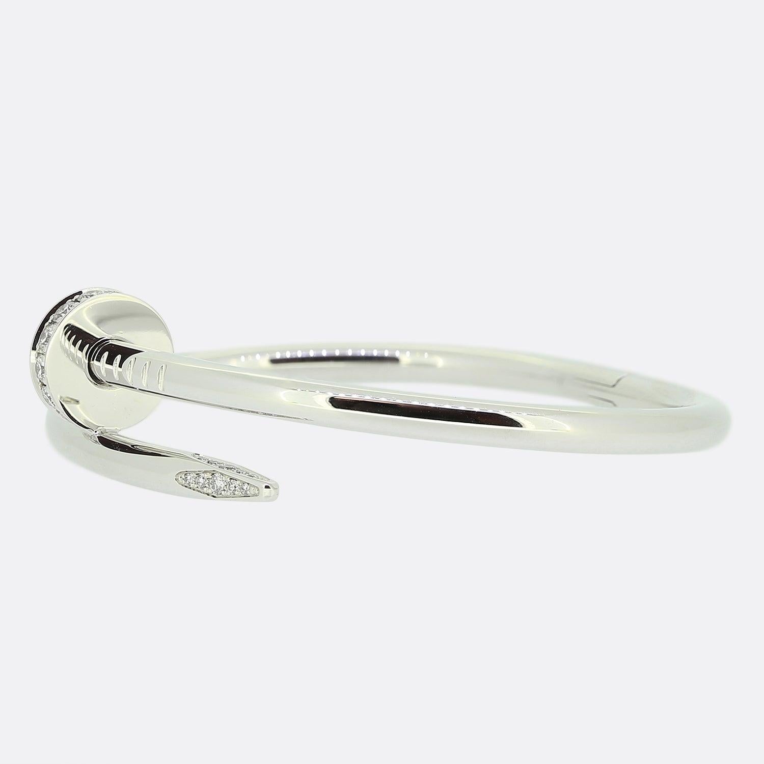 Here we have an 18ct white gold bracelet from the world renowned luxury jewellery house of Cartier. This piece forms part of their iconic Juste un Clou collection and showcases a wrap around nail design with a diamond set head and tip. This is the