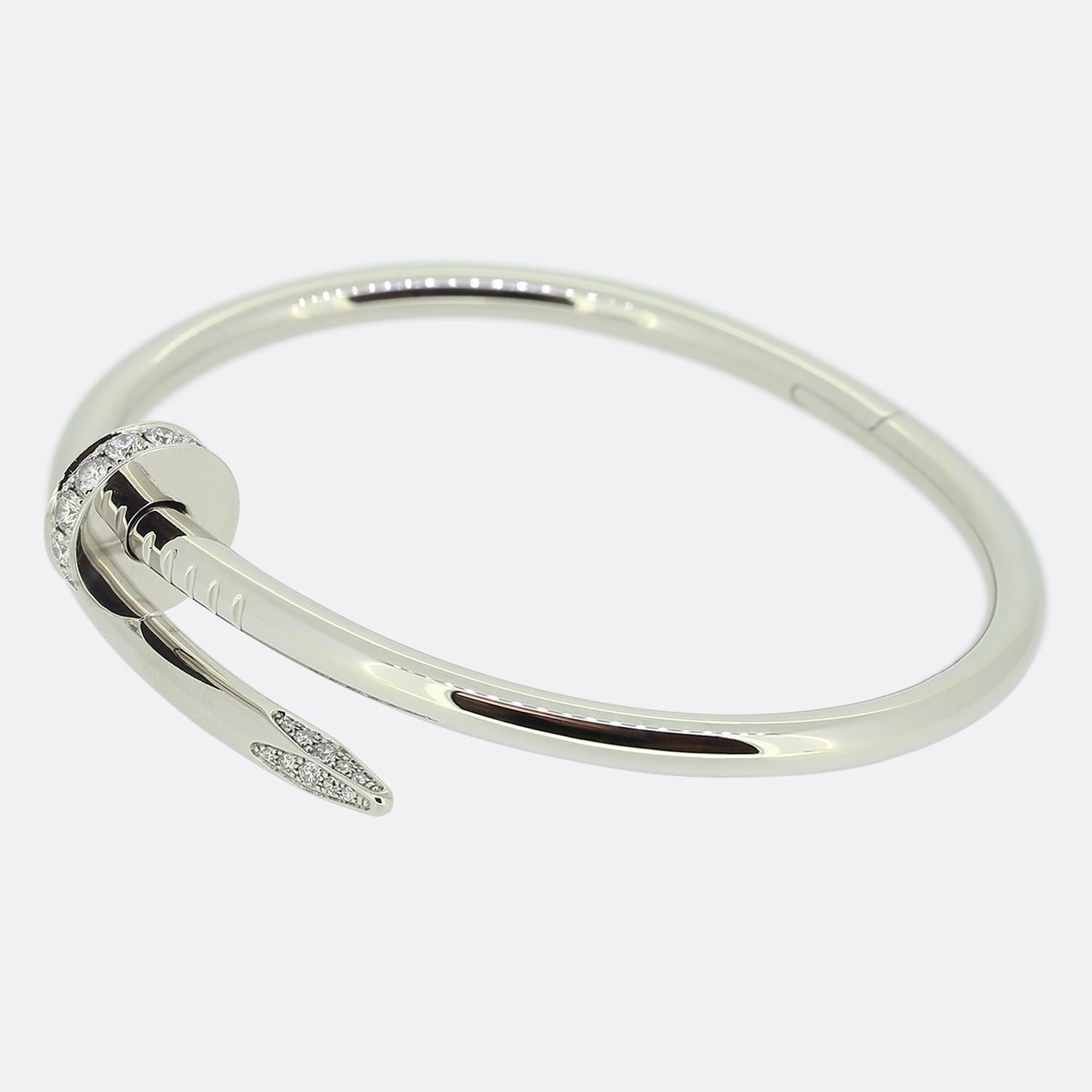 Here we have an 18ct white gold bracelet from the world renowned luxury jewellery house of Cartier. This piece forms part of their iconic Juste un Clou collection and showcases a wrap around nail design with a diamond set head and tip. This is the
