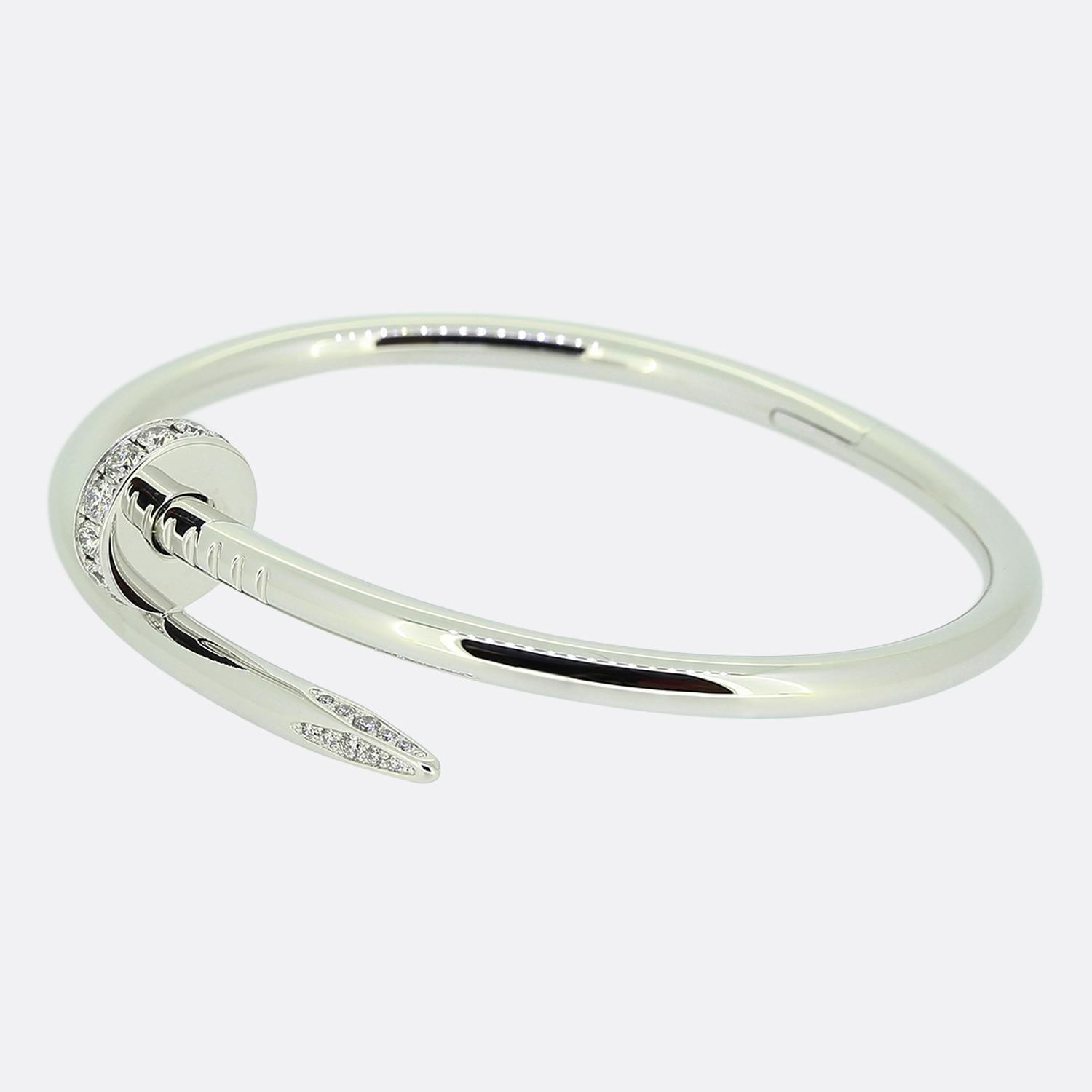 Here we have an 18ct white gold bracelet from the world renowned luxury jewellery house of Cartier. This piece forms part of their iconic Juste un Clou collection and showcases a wrap around nail design with a diamond set head and tip. This is the