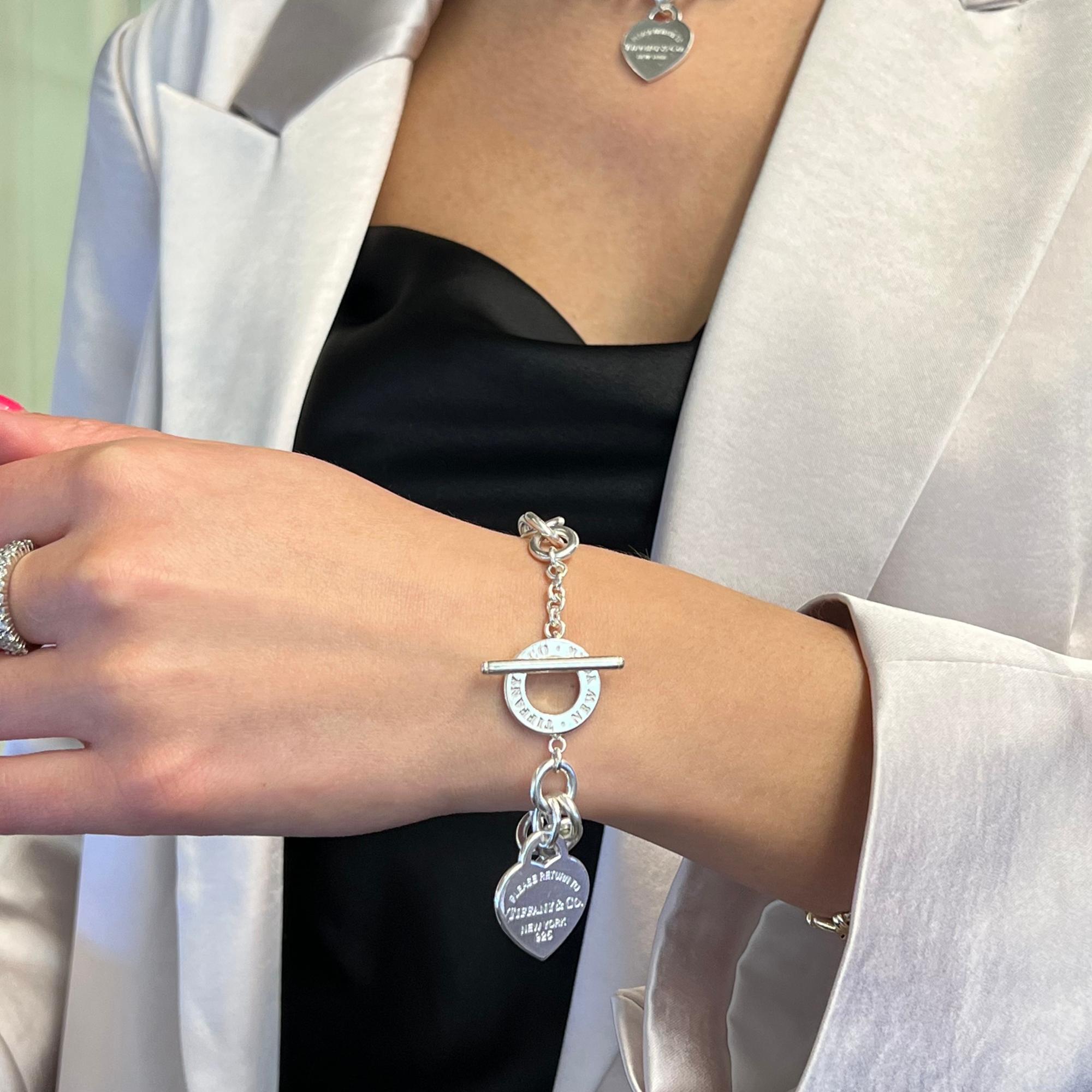 With a truly classic and elegant design, this bracelet embodies the collection's celebrated aesthetic. Designed in sterling silver 925. This corner hanging heart tag charm comes with engraving on the front and stamped on the back. Comes with a