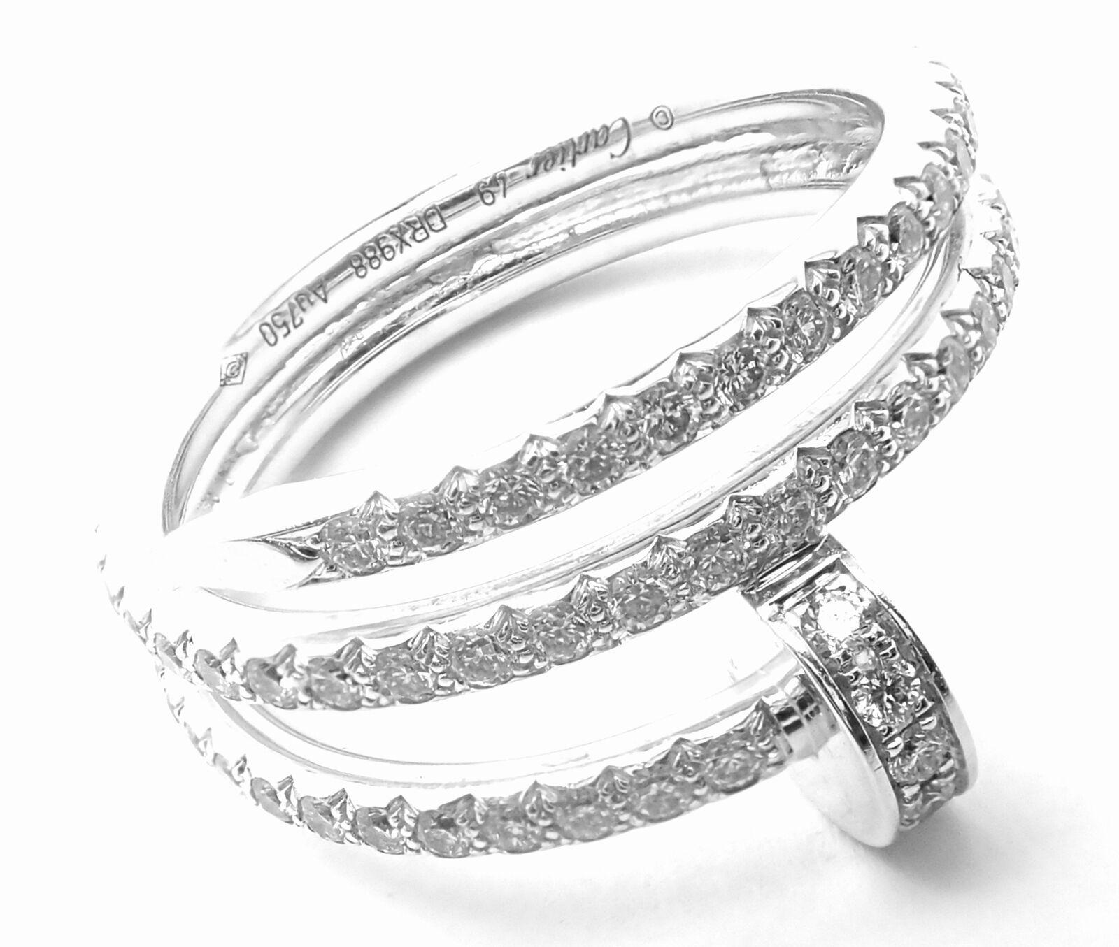 18k White Gold Diamond Juste un Clou Nail Band Ring by Cartier.
With 77 round brilliant cut diamonds VVS1 clarity, E color total weight approximately 0.59ct 
Details:
Size: European 49, US 4.75
Weight: 4.9 grams
Width: 11mm
Stamped Hallmarks: 750