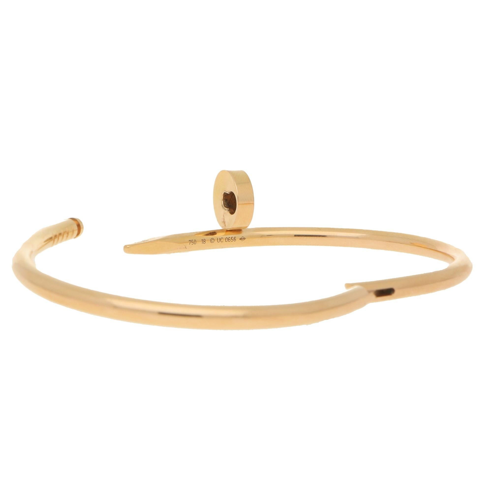 A classic Cartier Juste Un Clou bangle set in 18k rose gold. 

The bangle is from the older Juste Un Clou collection which means it is a little heavier in weight and has a different clasp mechanism. Unlike the modern bangles that have a hidden