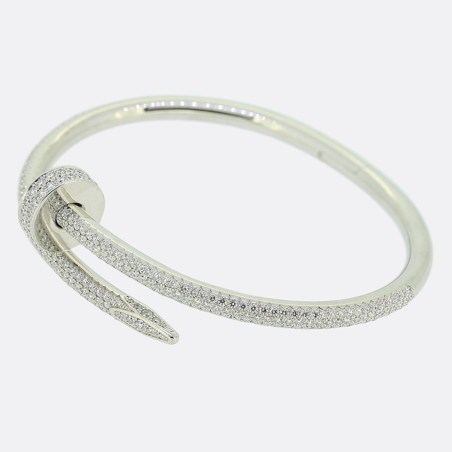Here we have an 18ct white gold bracelet from the world renowned luxury jewellery house of Cartier. This piece forms part of their iconic Juste un Clou collection and showcases a wrap around nail design with the front of the piece being entirely