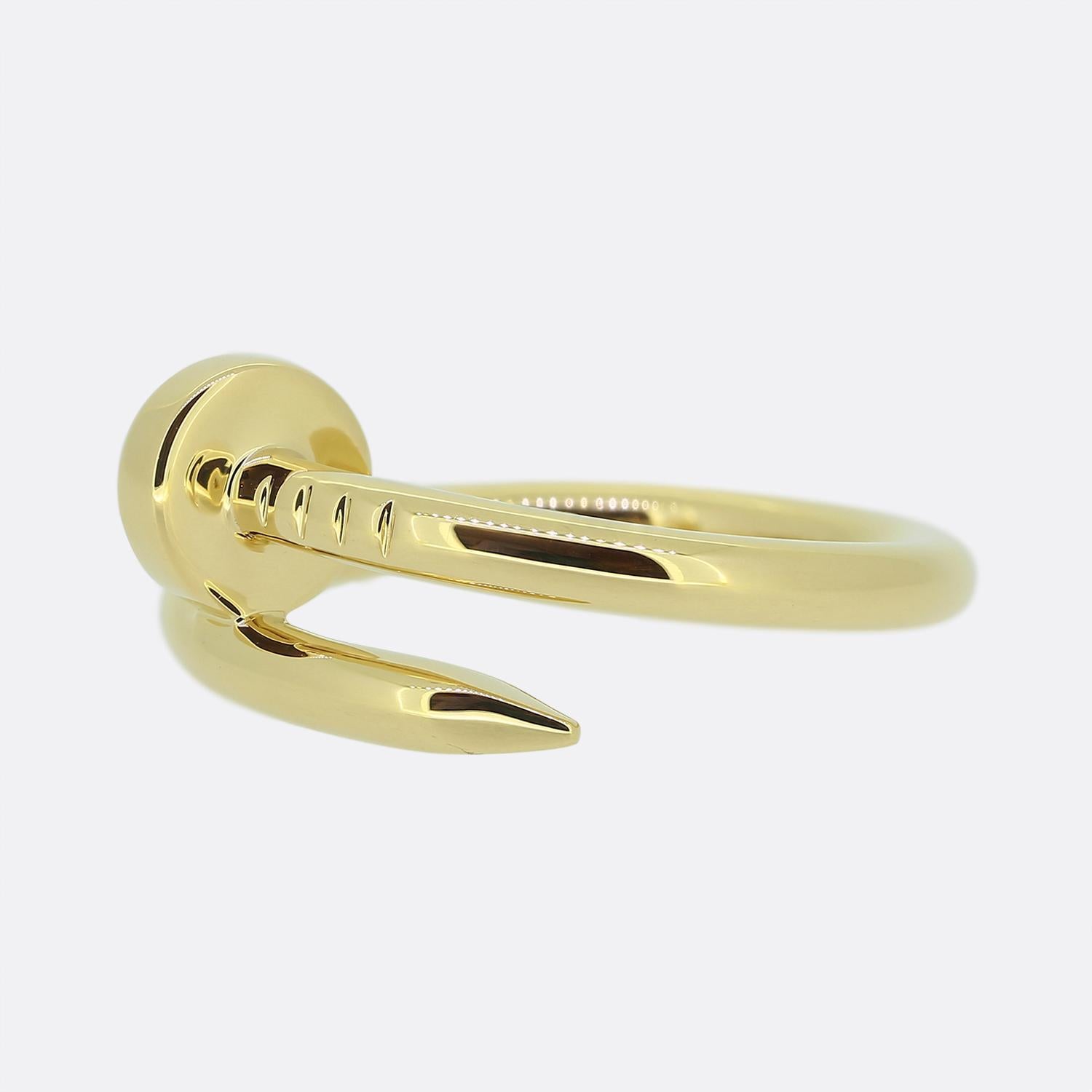 Here we have an excellently crafted 18ct yellow gold ring from the world renowned jewellery house of Cartier. This piece forms part of their iconic 'Juste un Clou' collection and showcases a wrap-around nail design. This is the standard model with a