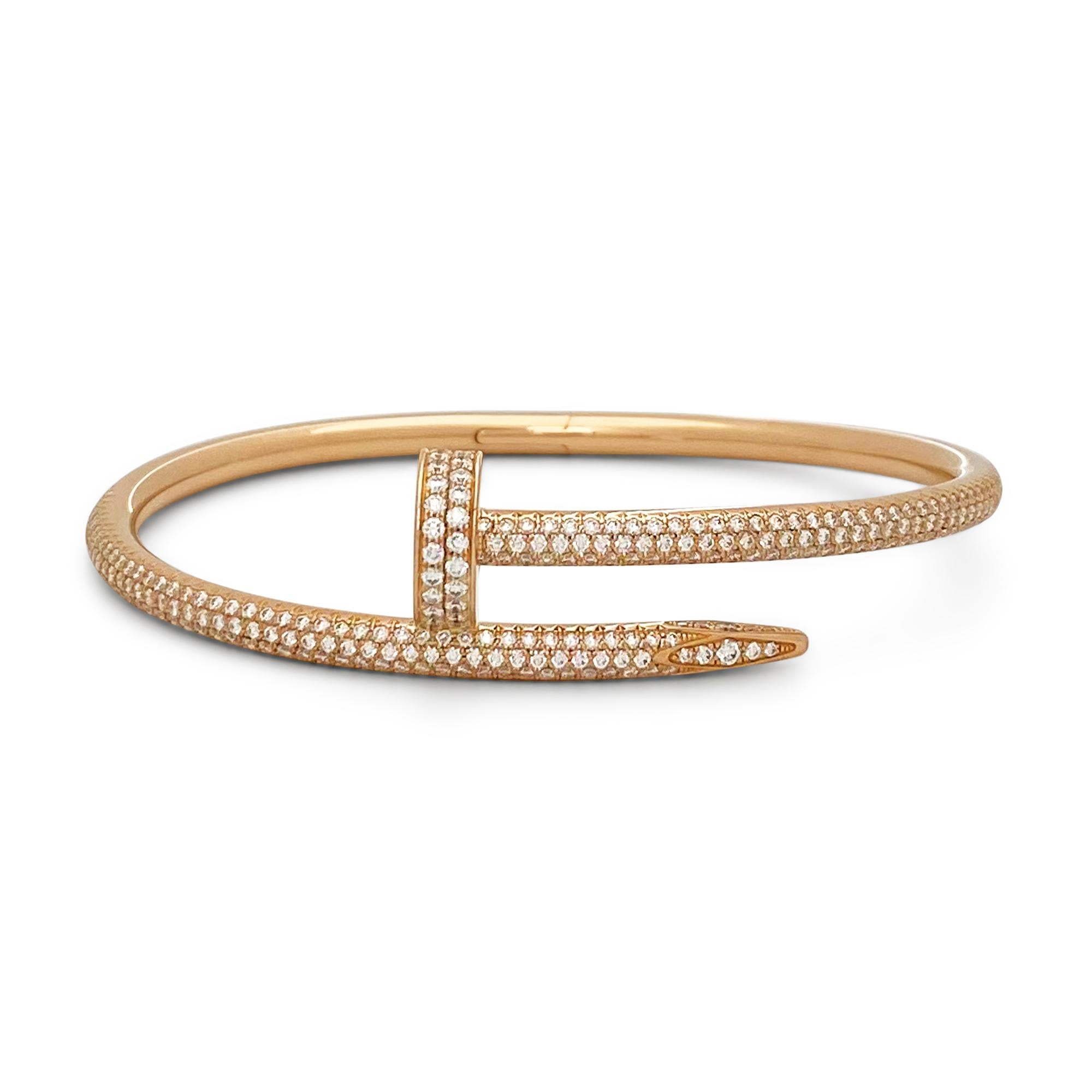 Designed as a 'just a nail', this authentic Cartier 'Juste un Clou' bracelet is an innovative twist on a familiar and ordinary object. The bracelet is set with high-quality round brilliant cut diamonds (E-F color, VS clarity) weighing an estimated