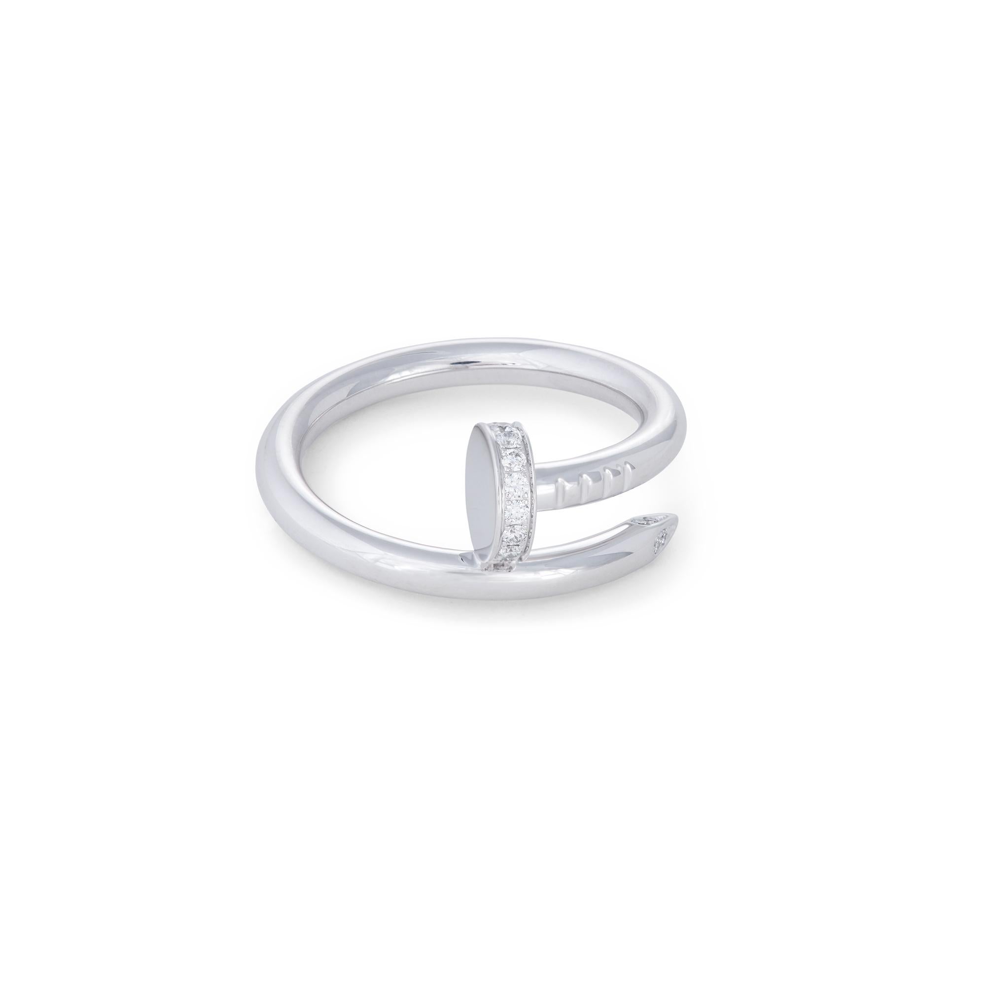 Authentic Cartier 'Juste un Clou' ring crafted in 18 karat white gold. The ring is set with approx. 0.13 carats of round brilliant cut diamonds (E-F color, VS clarity). Signed Cartier, 750. with serial number and hallmark. Size 55 (US 7 1/4).