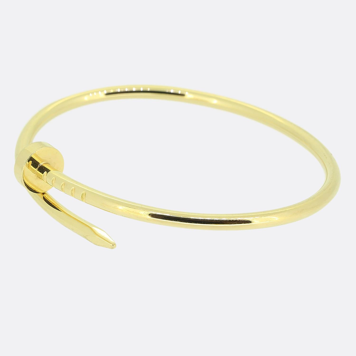 Here we have an 18ct yellow gold bracelet from the luxury jewellery house of Cartier. The particular piece forms part of their world renowned Juste un Clou collection and showcases a wrap around nail design. This is the small model which allows the