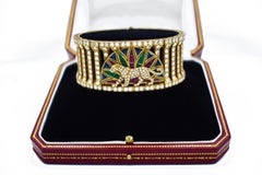 Cartier l Armband „Panthere“ aus Gold, farbigem Stein und Diamanten.