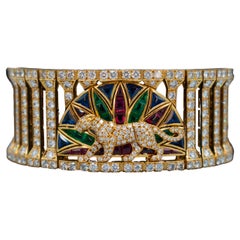 Cartier l Armband „Panthere“ aus Gold, farbigem Stein und Diamanten.