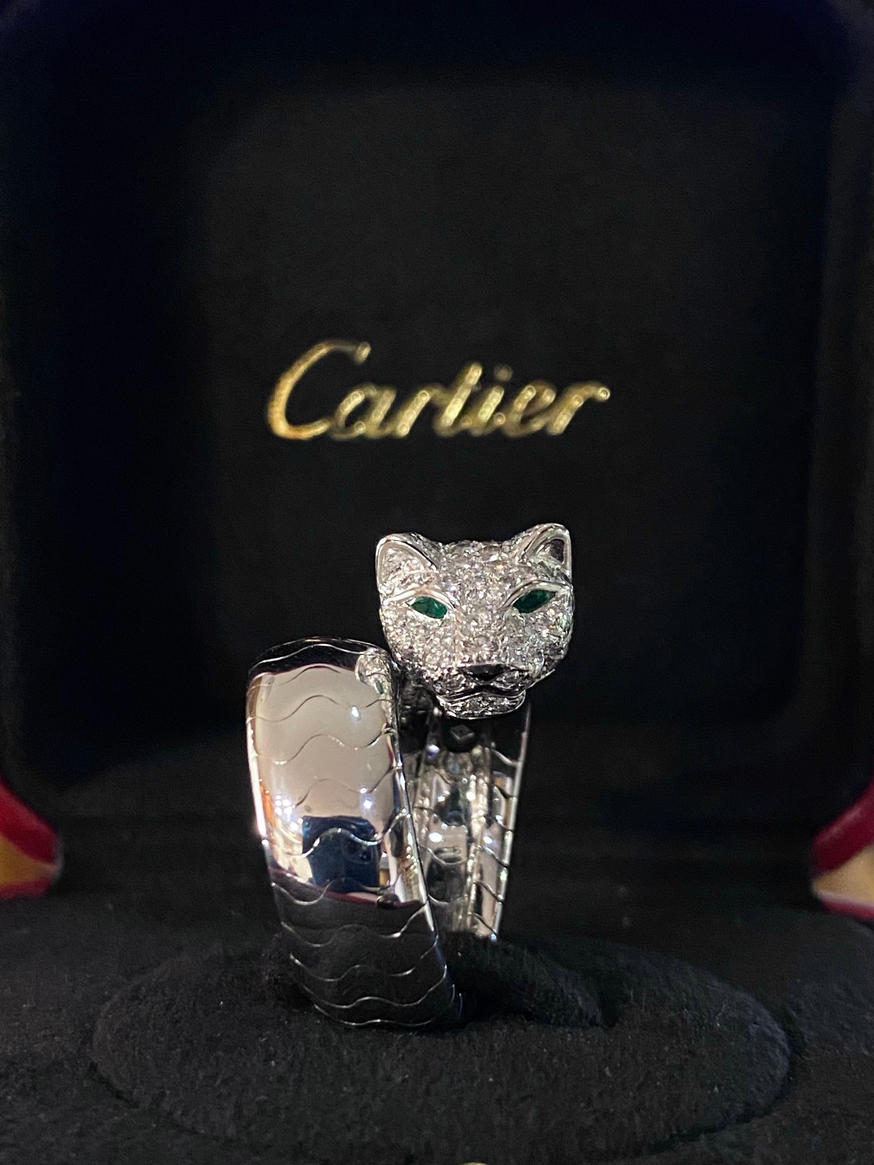 A rare Cartier Panthere diamond, emerald and onyx cocktail ring in 18kt white gold, France, 2000s, with maker’s box and outer box. In the Maison’s iconic motif and designed as an open ring, this jewel is modelled in the shape of a panther’s head