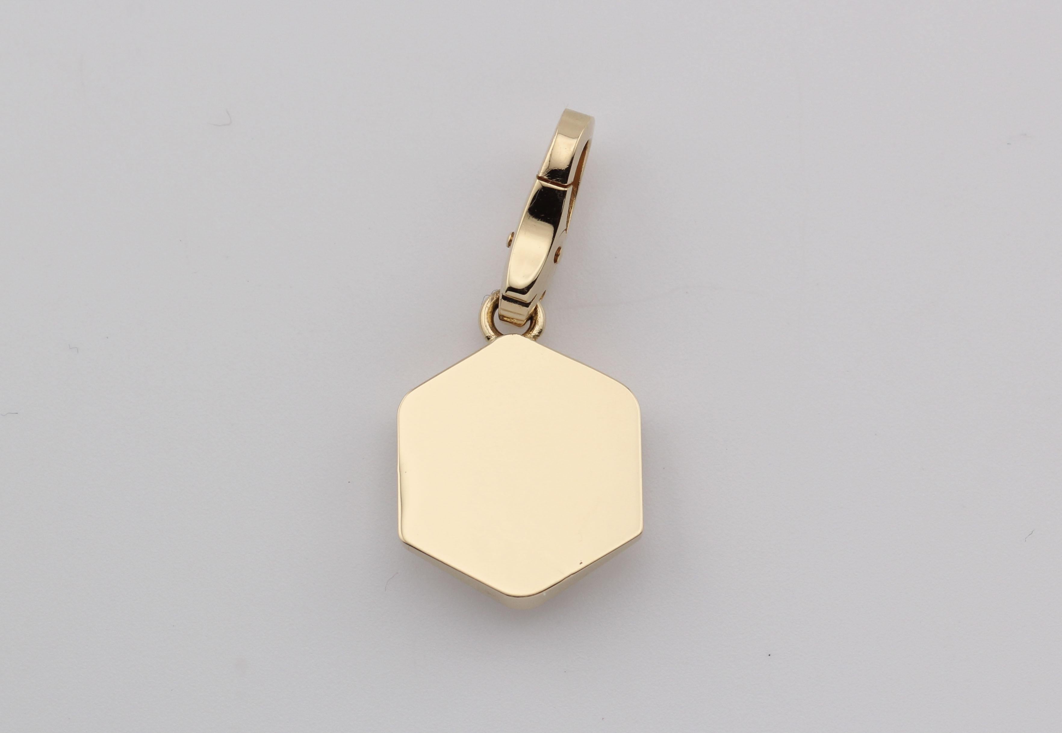 The Cartier Lacquer 18K Yellow Gold Dice Charm Pendant is a playful yet sophisticated creation, embodying the house’s flair for blending luxury with whimsical design. Crafted from rich 18K yellow gold, this exquisite charm takes the form of a