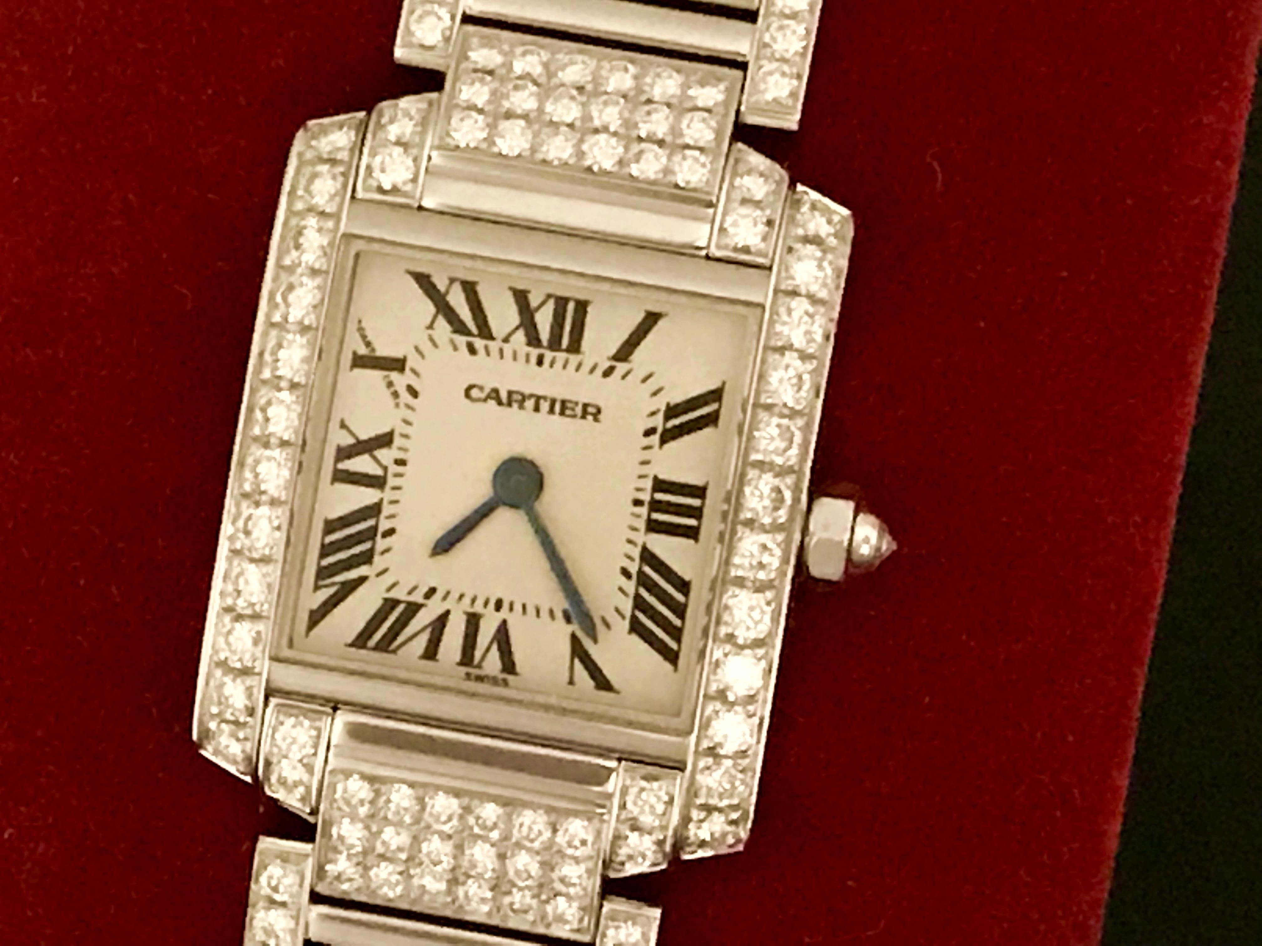 Very rare Cartier Ladies Tank Francaise Model WE1002SD in Like New Condition. Quartz movement. 18k White Gold case with Cartier pave Diamond bezel and Diamond cabachon setting crown (20x25mm). 18k White Gold Cartier full pave Diamond bracelet with
