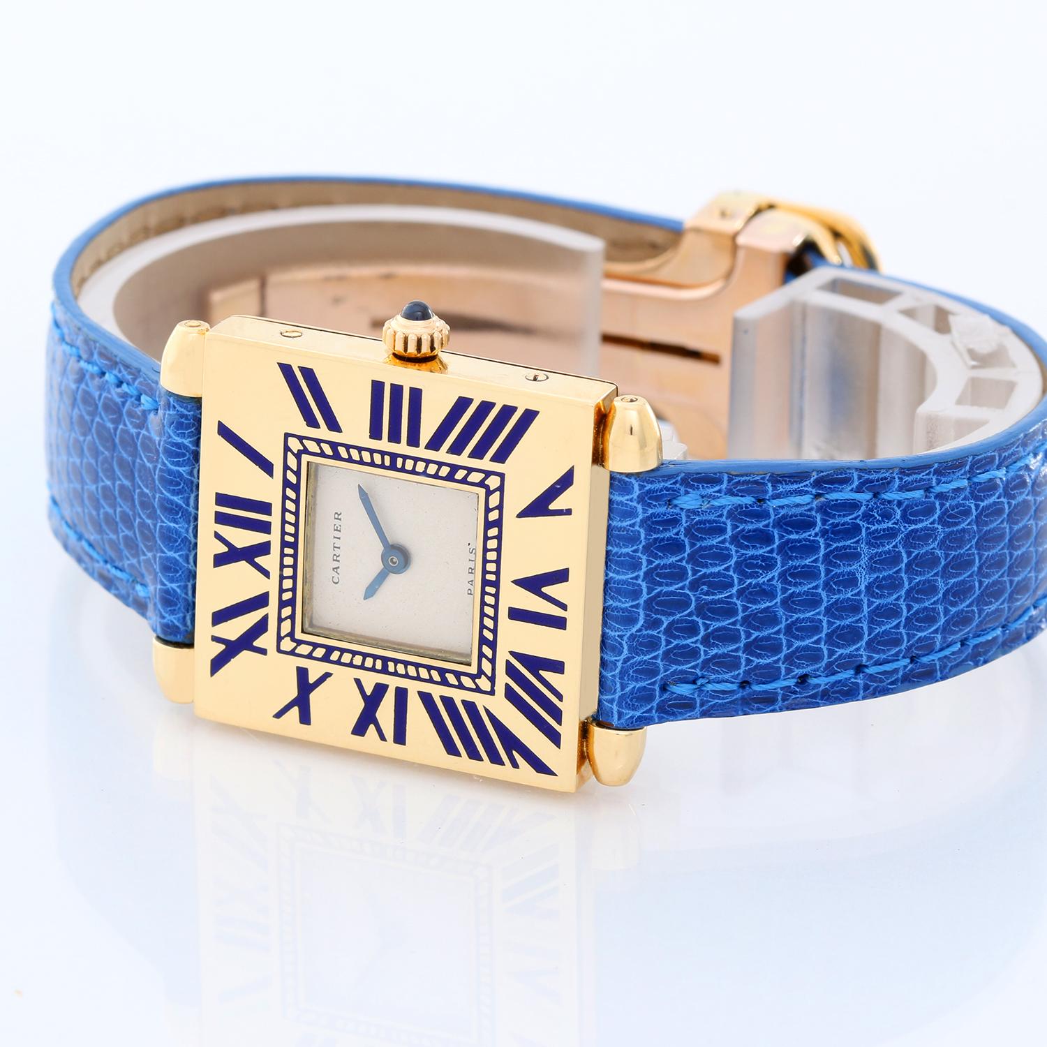 Cartier 18k Yellow Gold Quadrant Ladies Watch - Quartz. 18K Yellow gold ( 25 mm x 32 mm ) grained blue Roman numerals. Ivory dial with blue hands. Blue Cartier leather strap. Pre-owned with custom box.