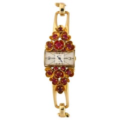 Montre-bracelet Cartier pour femme en or jaune sertie de rubis