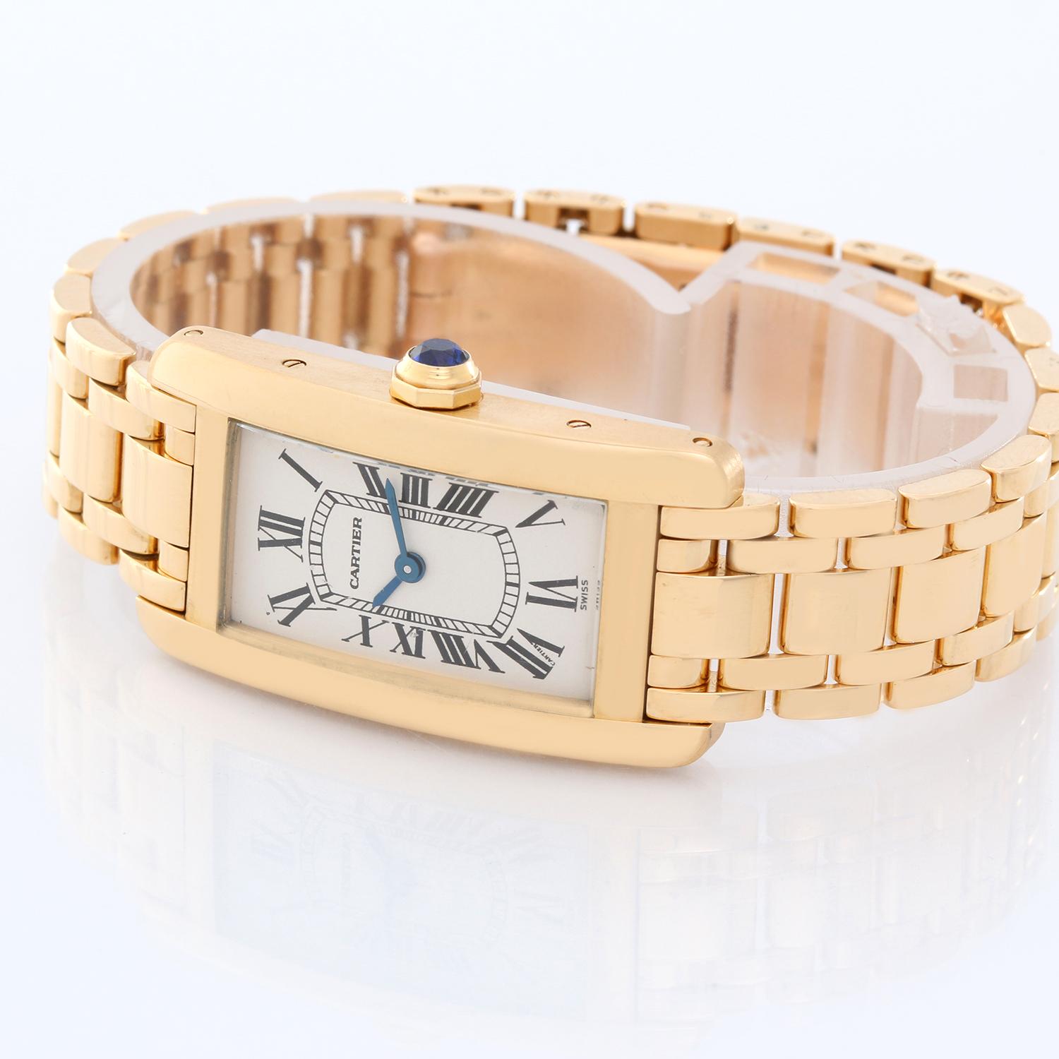 Cartier Tank Americaine Ladies 18k Yellow Gold Watch -  Quartz. 18k yellow gold case (19mm x 35mm). Ivory colored dial with black Roman numerals. 18K yellow gold Cartier bracelet.  Pre-owned with box.