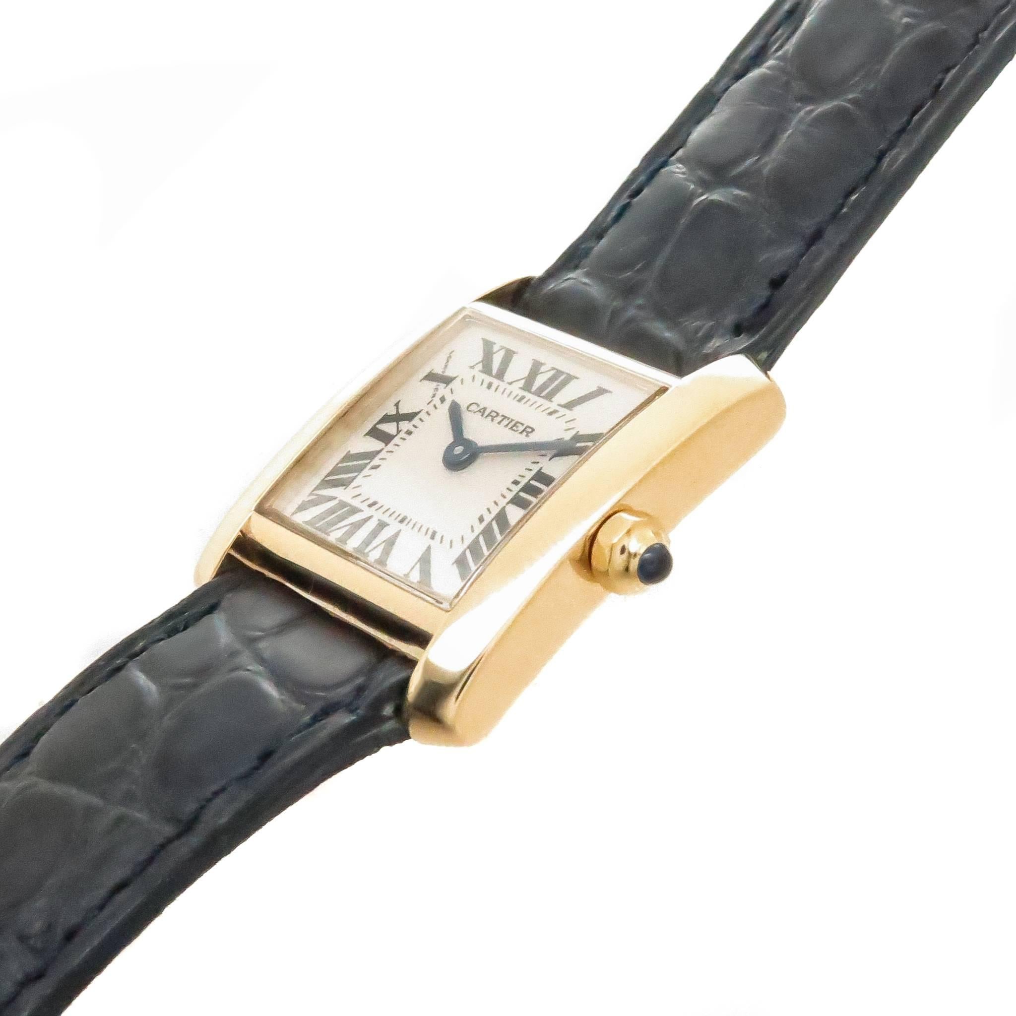 Circa 2012 Cartier Ladies Tank Francaise Wrist Watch, 25 X 20 MM 18K Yellow Gold case, Quartz Movement, White Dial with Black Roman Numerals, sapphire Crown.  New Cartier Navy Blue Croco strap with 18K Gold Tang Buckle. Watch length 8 3/4 inches.
