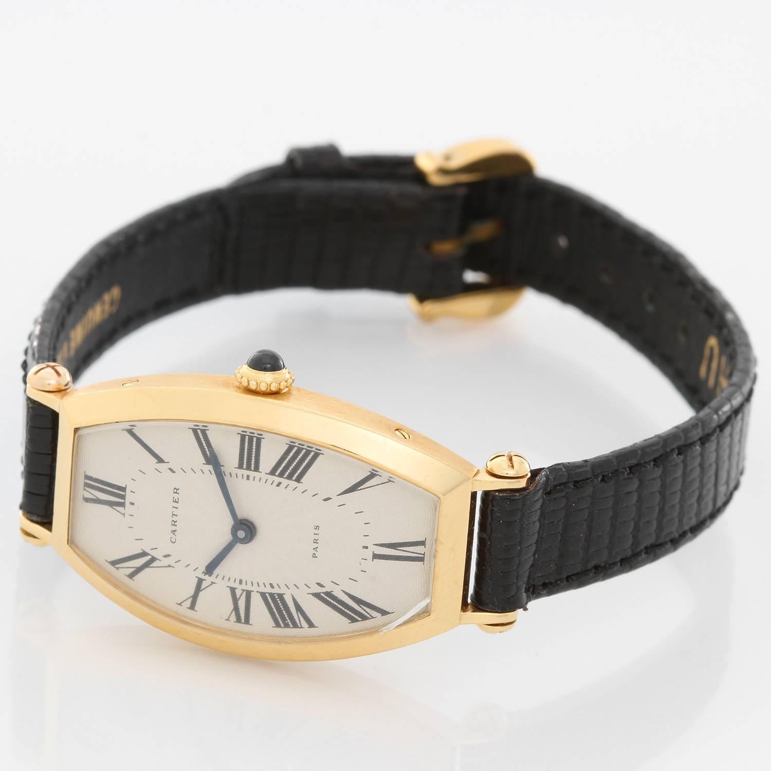 Cartier Tonneau Ladies Yellow Gold Watch - Manual winding. 18K Yellow gold ( 21 x 32 mm ). Silvered Guilloche dial with blue hands. black lizard strap with tang buckle. Pre-owned with Cartier box.