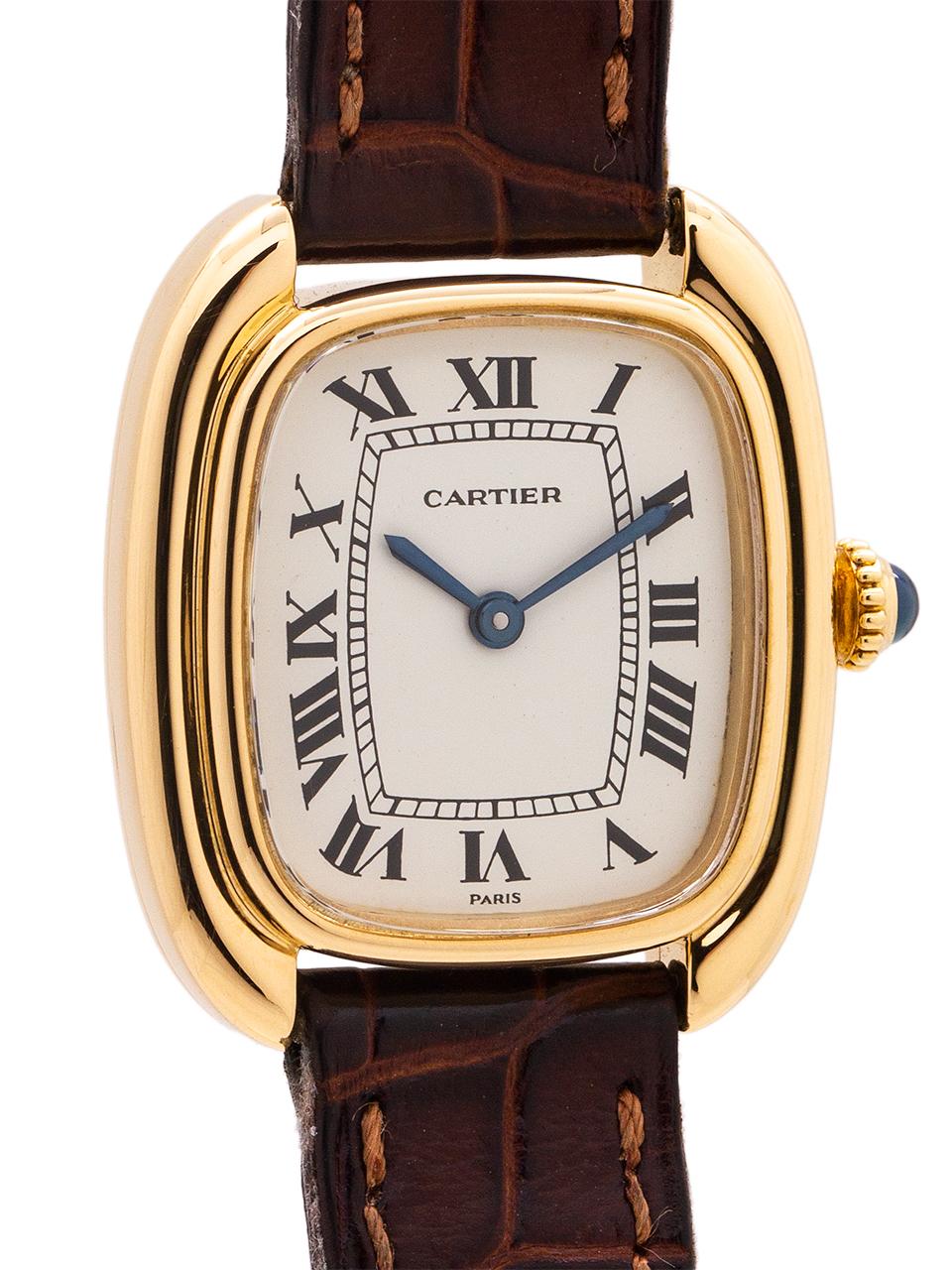 
Cartier 18K Yellow Gold lady Gondole model circa 1970’s. Scarce and great looking elongated 24 x 29mm cushion shaped case with sculpted and stepped sides. With mineral glass crystal and original glossy white classic Cartier dial with Roman figures