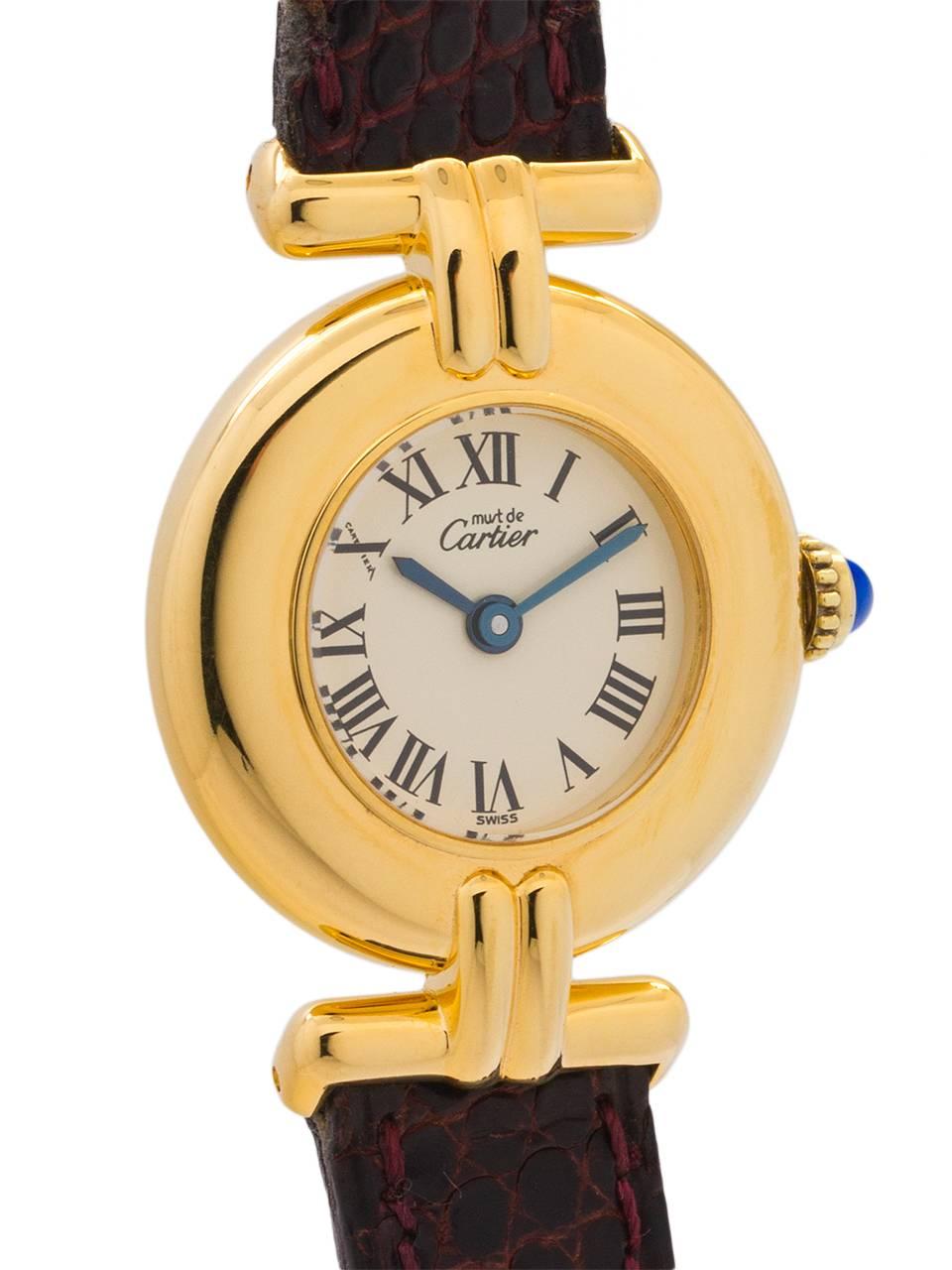 
Cartier Lady’s Must de Colisee circa 1990s. Featuring 23 x 31mm round vermeil (20 microns gold over silver) case with wide dome bezel, sapphire crystal, silvered dial with black Roman figures. Battery powered quartz movement with cabochon sapphire