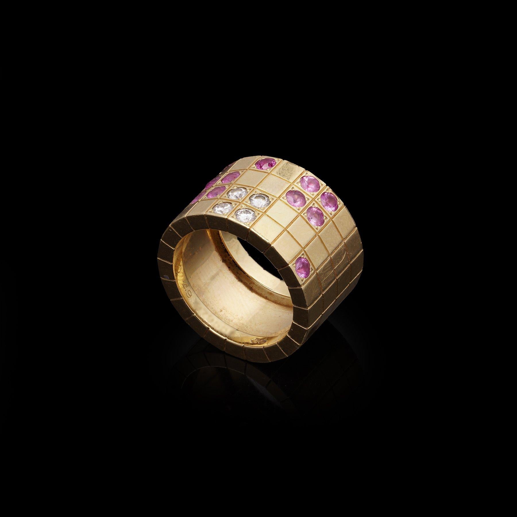 Cartier Lanieres 18K Yellow Gold Diamond and Pink Sapphire Ring. 

A striking and contemporary wide band ring by Cartier from the celebrated Lanieres collection, crafted in 18-karat yellow gold. The ring is composed of a grid-like mosaic design, set